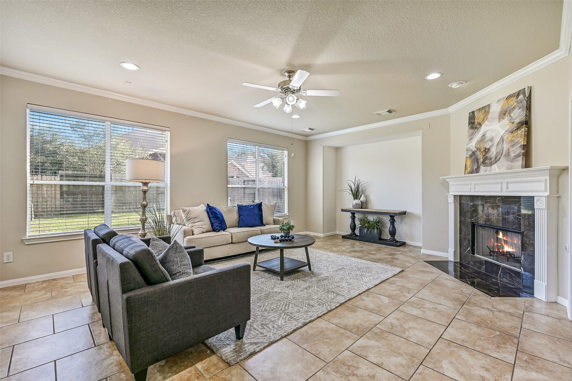 2508 Rockygate Lane, Friendswood, TX 77546 The spacious family room serves as the centerpiece of the home, offering generous space for everyday living and entertaining. Large rear-facing windows fill the room with natural light, while crown molding, recessed lighting, a ceiling fan, and easy-maintenance tile flooring create a comfortable and inviting atmosphere.