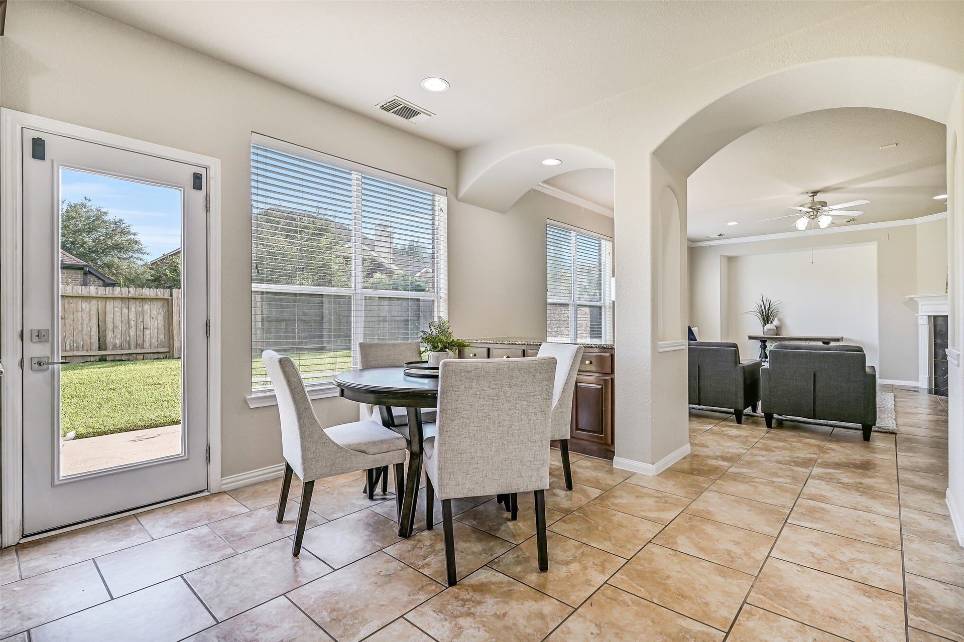 2508 Rockygate Lane, Friendswood, TX 77546 Another view of the breakfast room highlights the seamless connection to the family room and the built-in buffet tucked beneath the windows. Whether hosting a crowd or enjoying a quiet evening at home, this open-concept design offers the flexibility today's buyers are looking for.