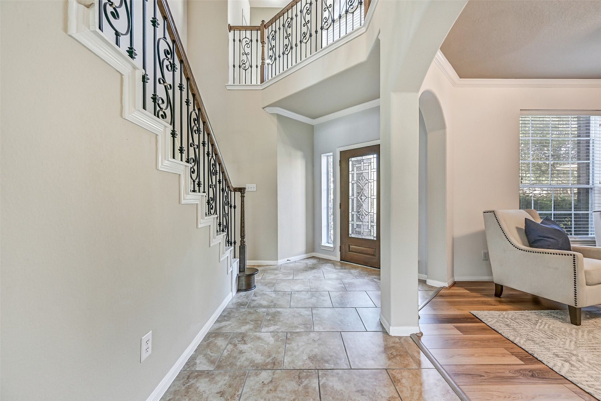 2508 Rockygate Lane, Friendswood, TX 77546 From the foyer, notice the graceful arched openings, soaring ceiling, and open sightlines that set the tone for this spacious floorplan. Fresh interior paint provides a clean, move-in-ready backdrop, while the staircase serves as a stunning architectural centerpiece connecting both levels of the home.