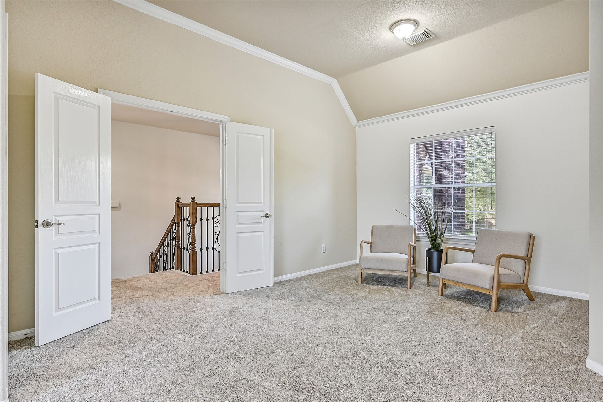 2508 Rockygate Lane, Friendswood, TX 77546 Double doors open into a truly impressive owner's retreat featuring fresh neutral paint, plush new carpet, crown molding, a lighted ceiling fan, and enough space for oversized furnishings with room to spare. The unique layout creates a private and peaceful atmosphere that feels more like a luxury suite than a traditional bedroom.