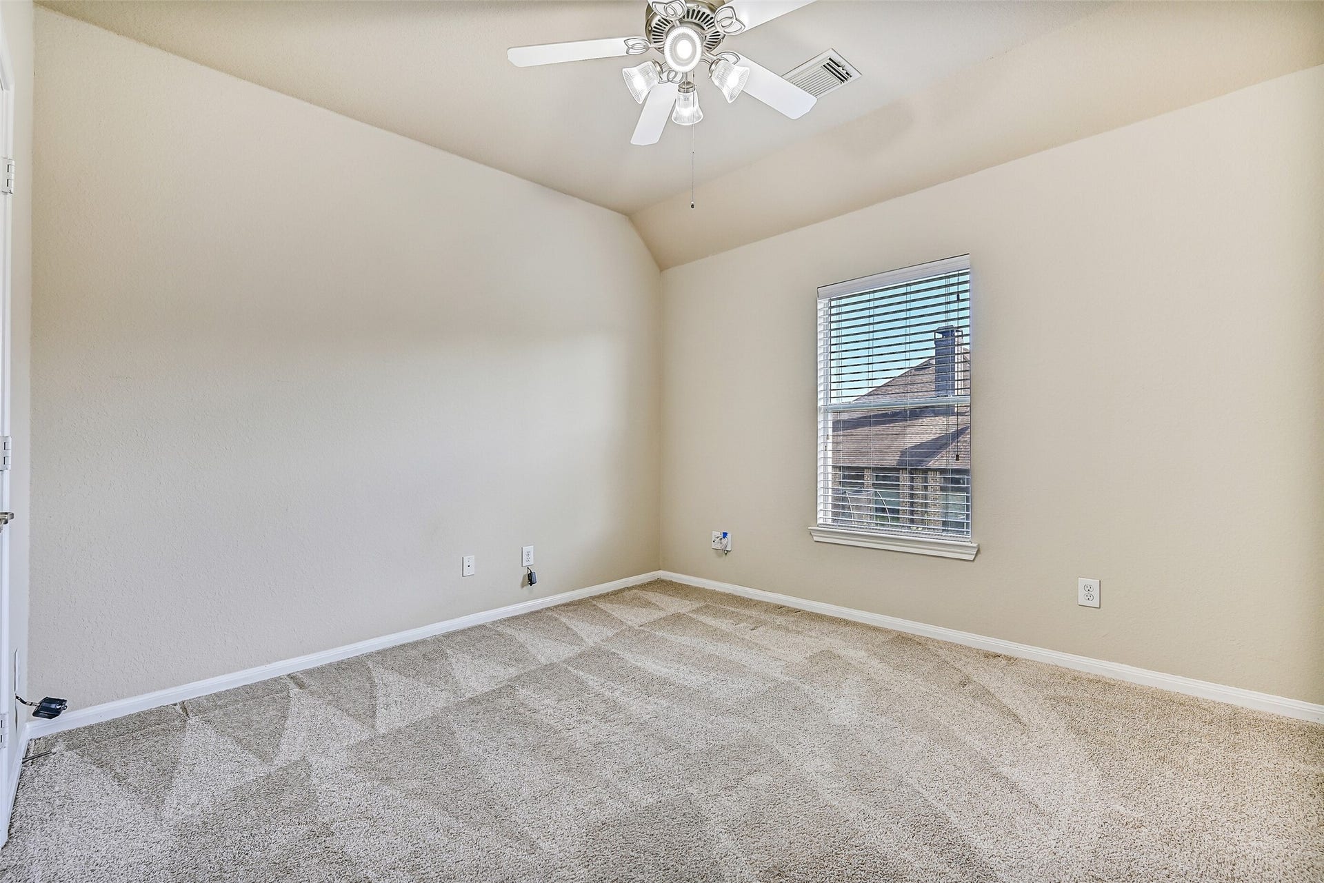 2508 Rockygate Lane, Friendswood, TX 77546 This generously sized secondary bedroom is the first of three bedrooms located on the second floor. Features include fresh neutral paint, plush new carpet, an elevated gambrel ceiling accented by a lighted ceiling fan, a step-in closet, and a side-facing window with 2-inch blinds that brings in abundant natural light.