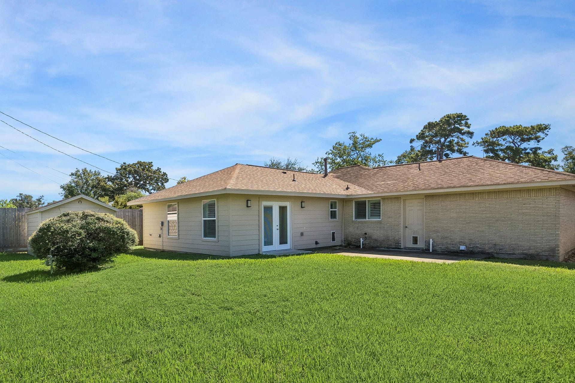 A dedicated laundry room offers space for a full-size washer and dryer, plus a convenient pet door providing direct backyard access for four-legged family members.