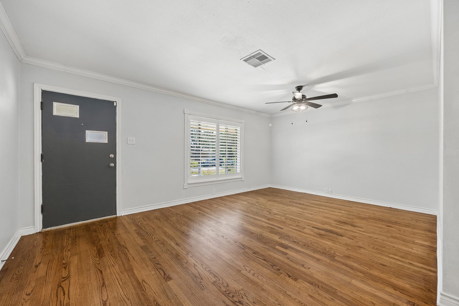 A closer look at the covered front porch and welcoming entry, offering a charming transition from the front yard into the home.
