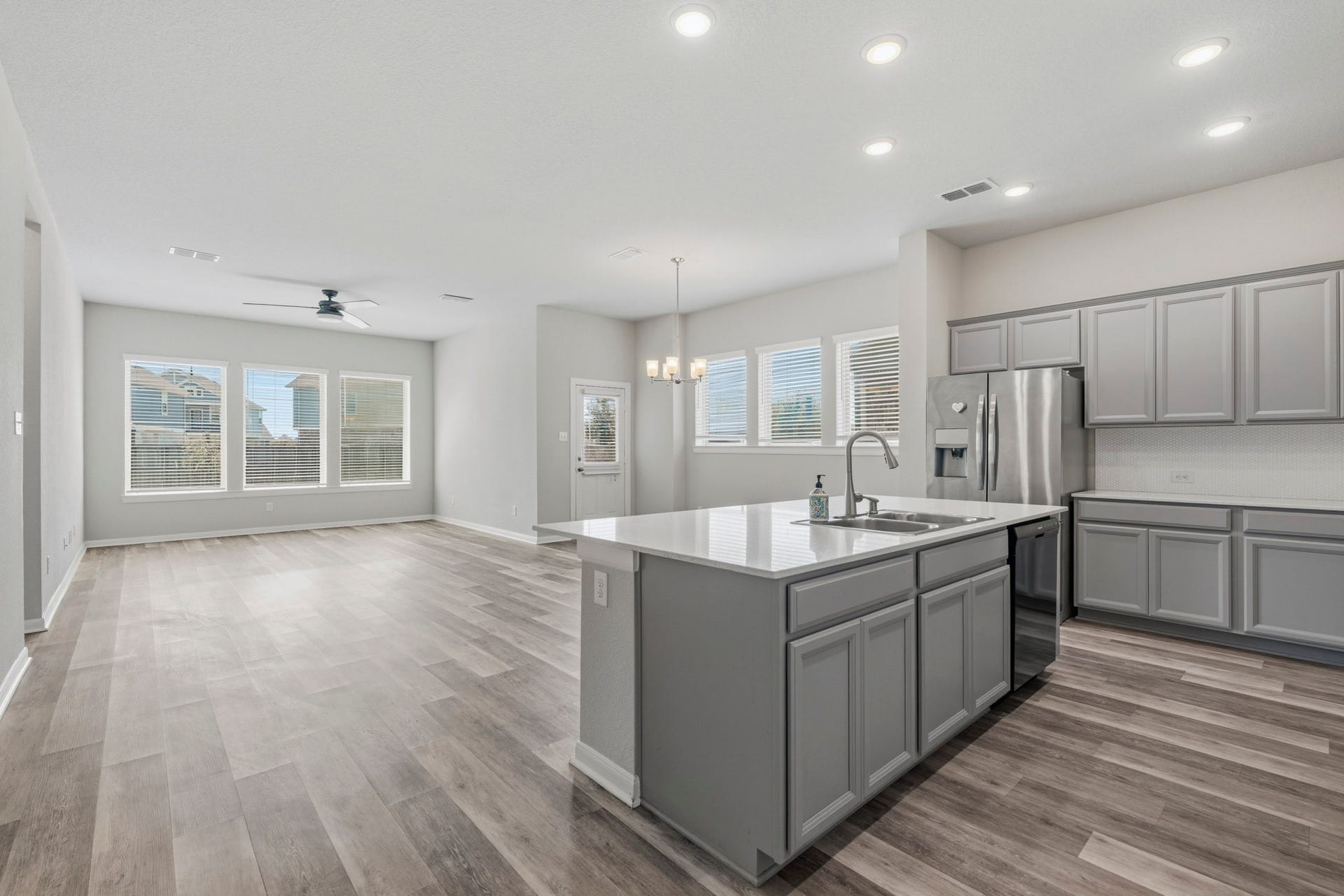 10055 Napier Drive, Iowa Colony, TX 77583 This bright and spacious kitchen sits at the heart of a modern open-concept floor plan, seamlessly connecting to adjacent dining and living areas.