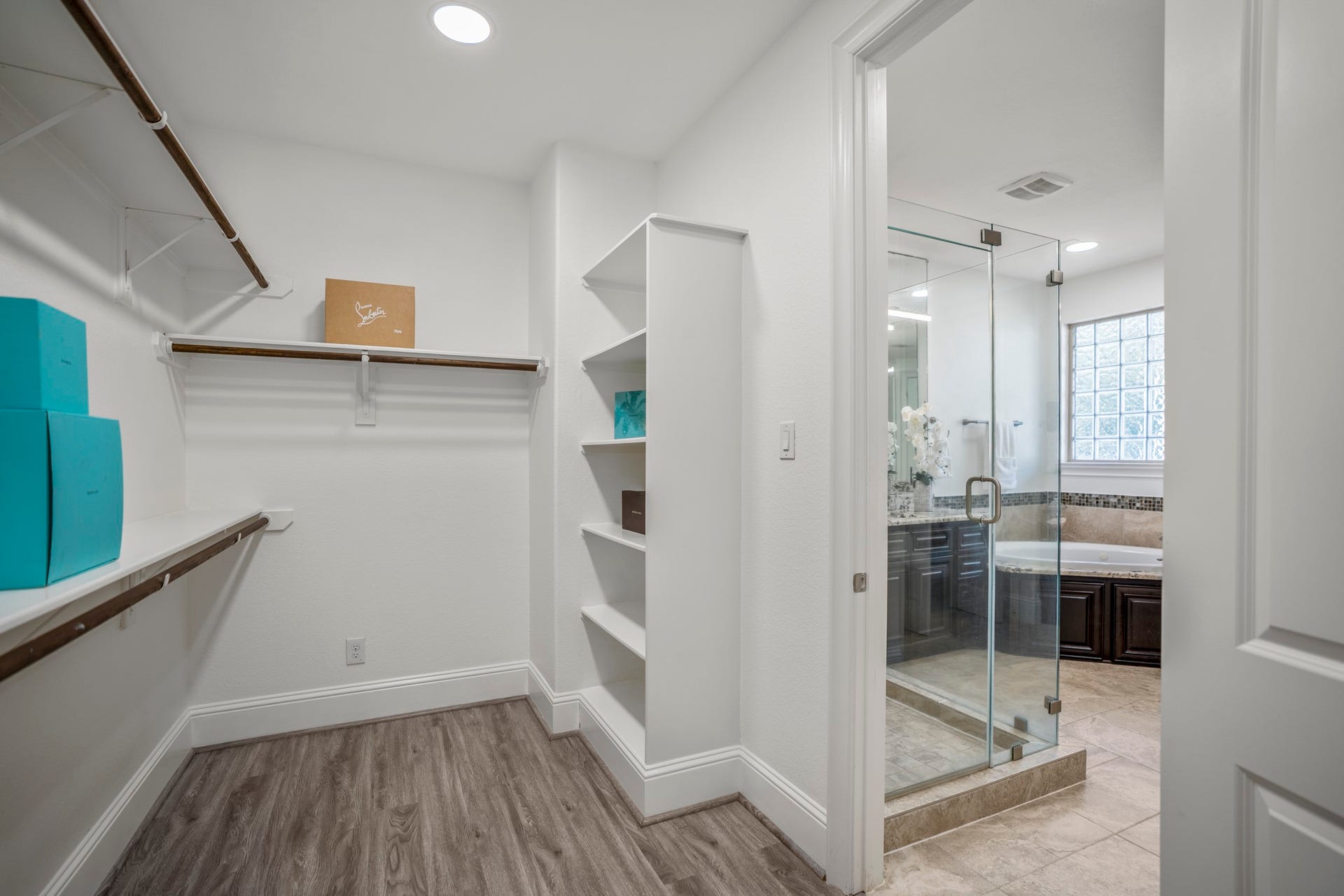 The expansive walk-in closet offers abundant hanging space, built-in organization, and room for every season's wardrobe.