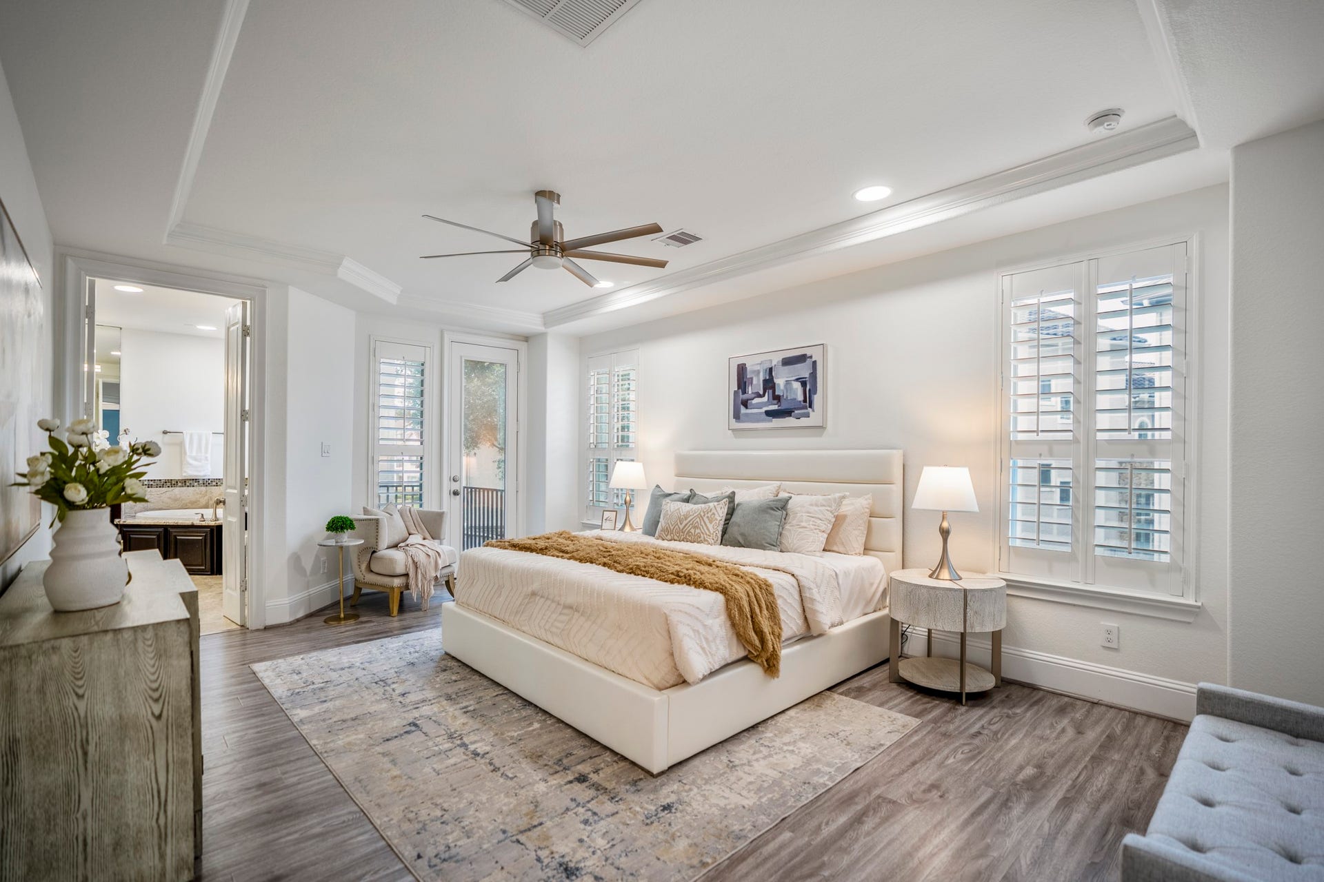 The spacious primary suite feels like a true retreat, complete with a sitting area, spa-inspired bath and peaceful private balcony.