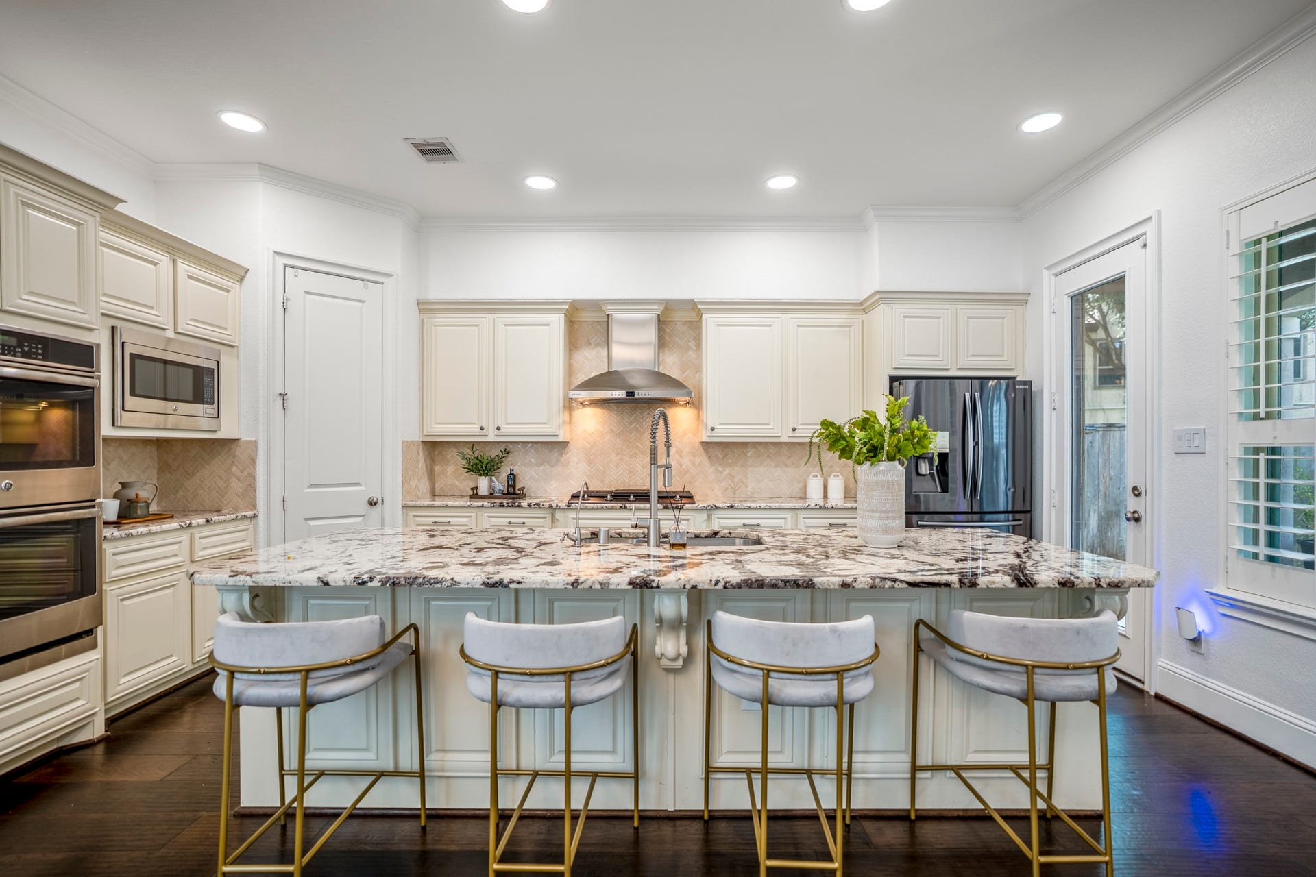 The chef's kitchen opens directly to the spacious living room, allowing conversations to continue whether you're preparing dinner or gathering with family and friends.