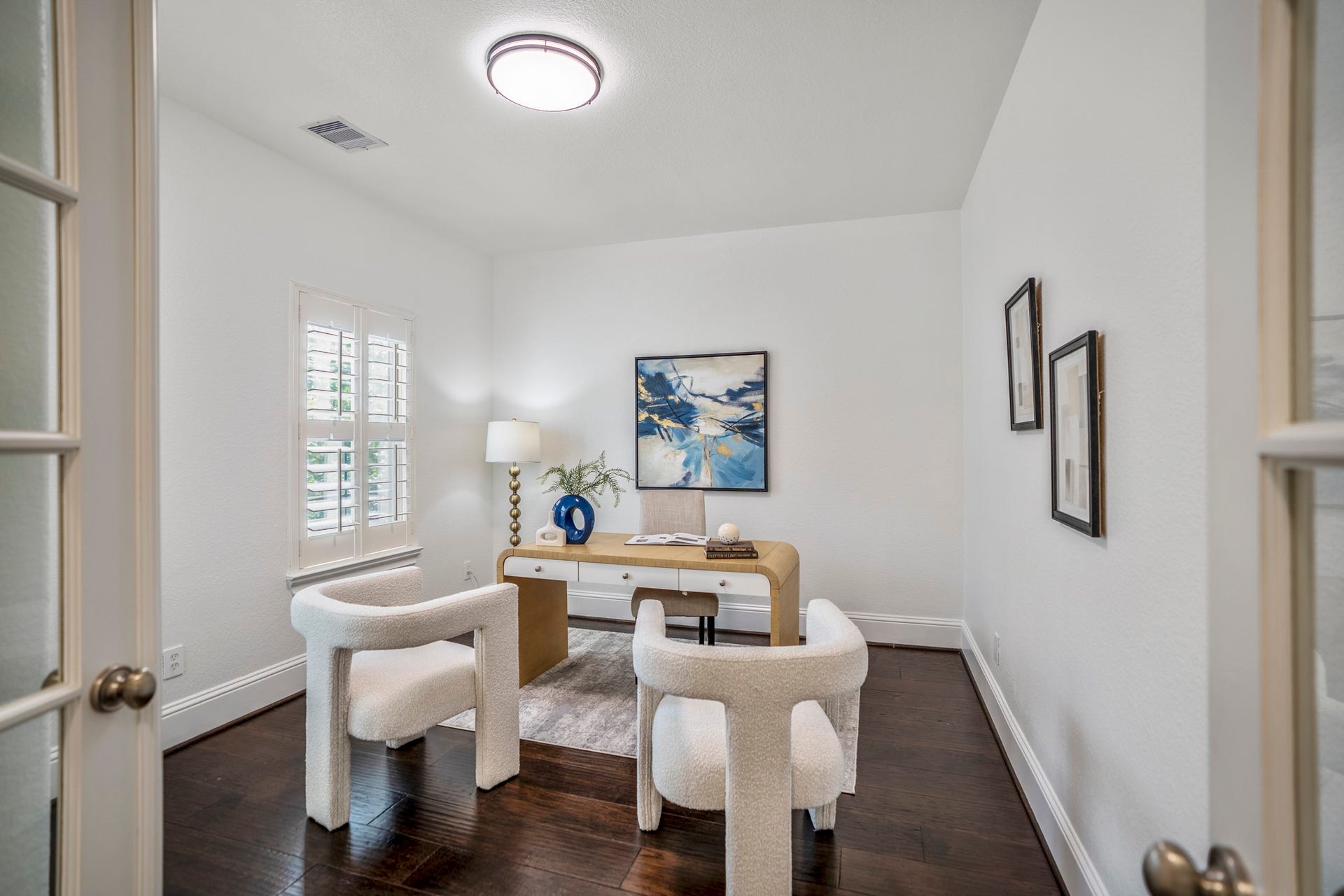 Privately tucked away on the second floor, the dedicated home office features elegant French doors and custom wood shutters, creating a quiet and sophisticated space for working from home or studying.