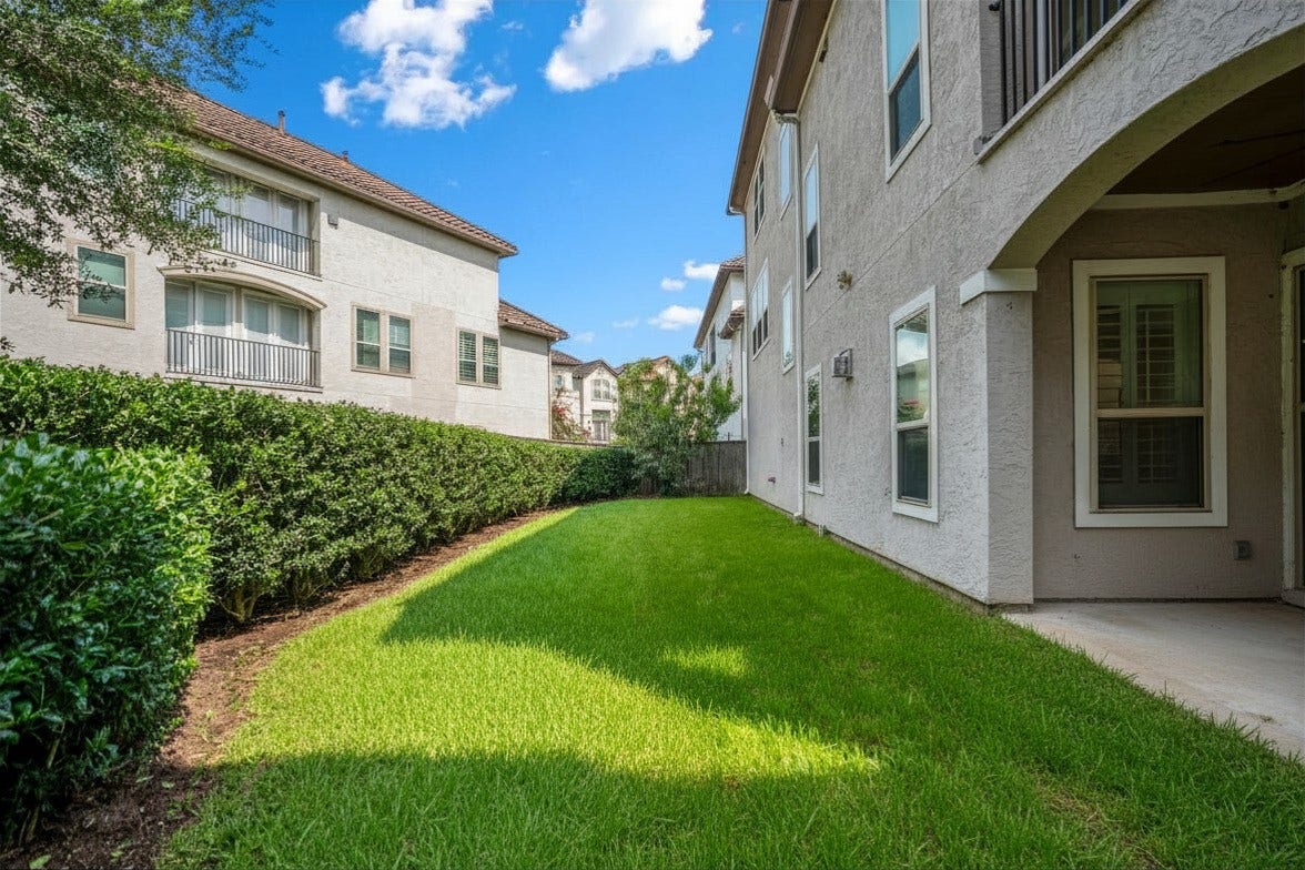 Having a spacious backyard in a gated community is rare, so this green space with a covered patio is a great addition that offers lots of room to relax or run around.