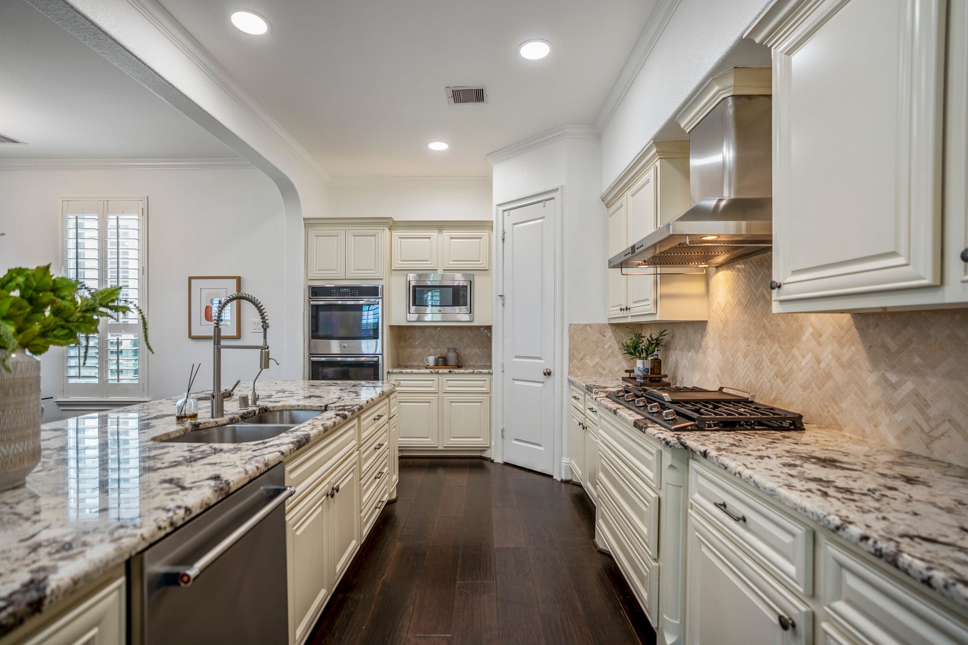 Timeless finishes, abundant cabinetry, and a spacious island make this beautifully appointed kitchen as functional as it is inviting.