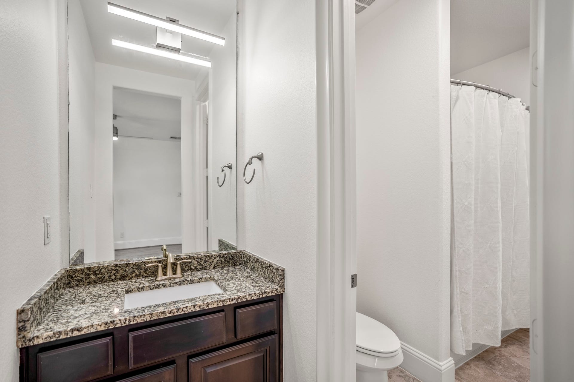 Two of the secondary bedrooms share a full bathroom, with their own separate sinks.
