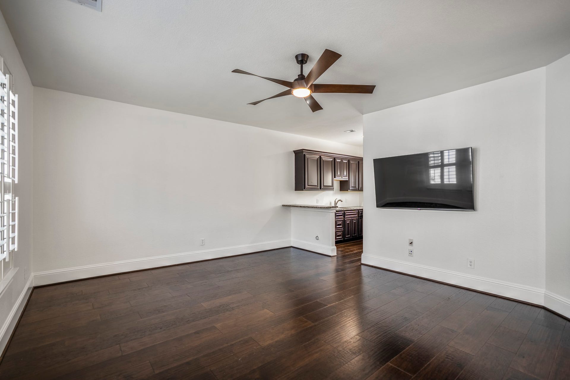A separate game room with a built-in bar creates the perfect flex space for movie nights, celebrations, or simply unwinding after a long day.