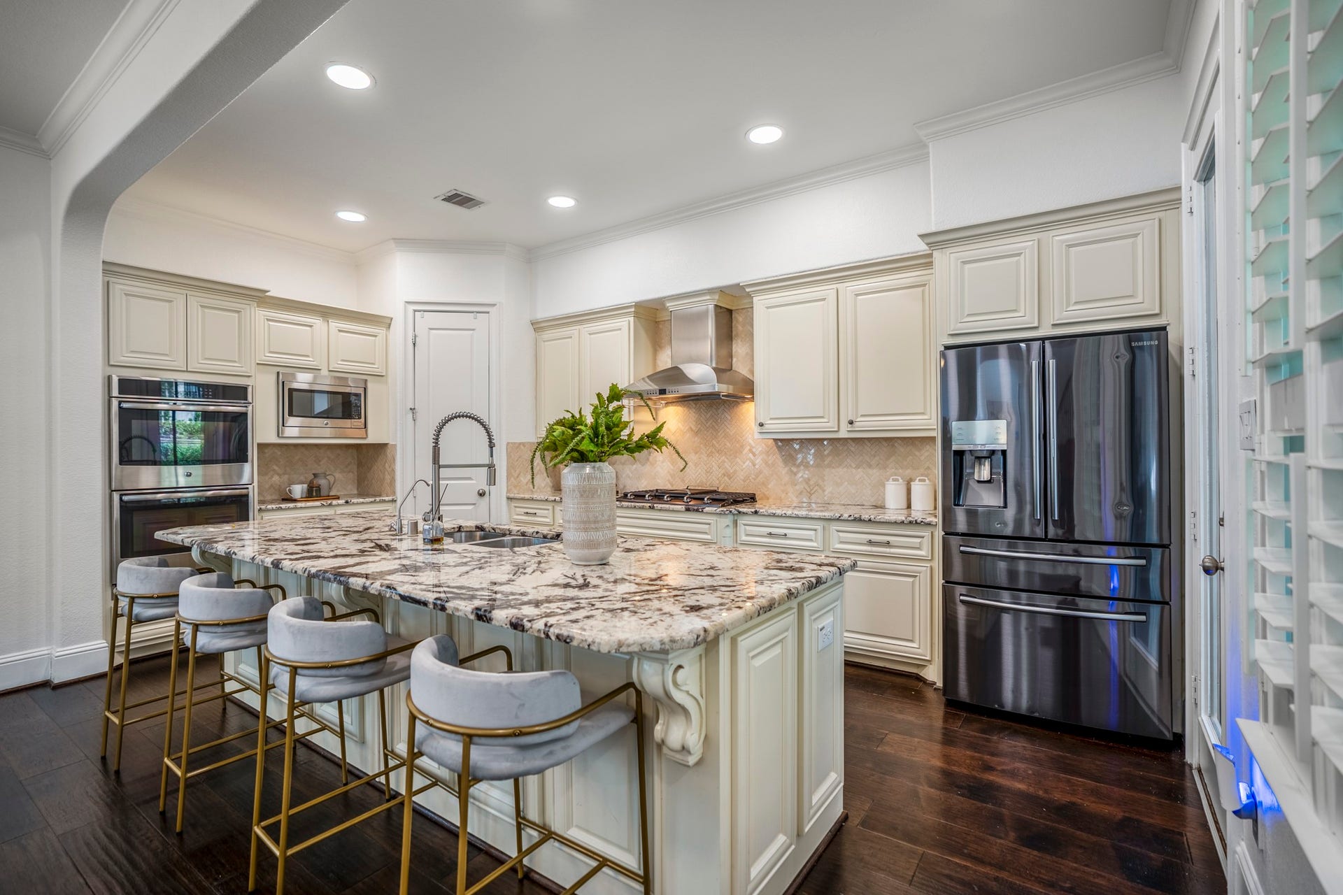 A generous island anchors the kitchen while overlooking both the dining area and living room, making this open-concept layout ideal for hosting.
