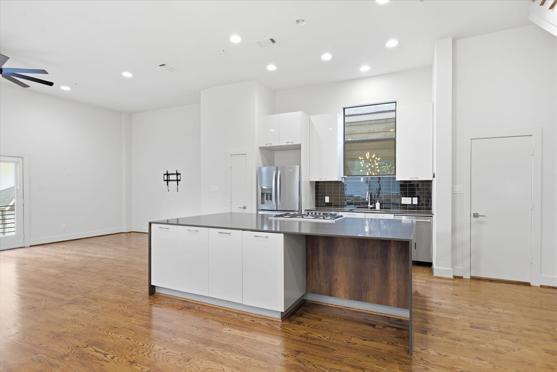 1215 Summer Street, #C, Houston, TX 77007 Door on the left (next to fridge) is the pantry. Door on the right is half bath for this floor - tucked away into a corner, but still conveniently close by!