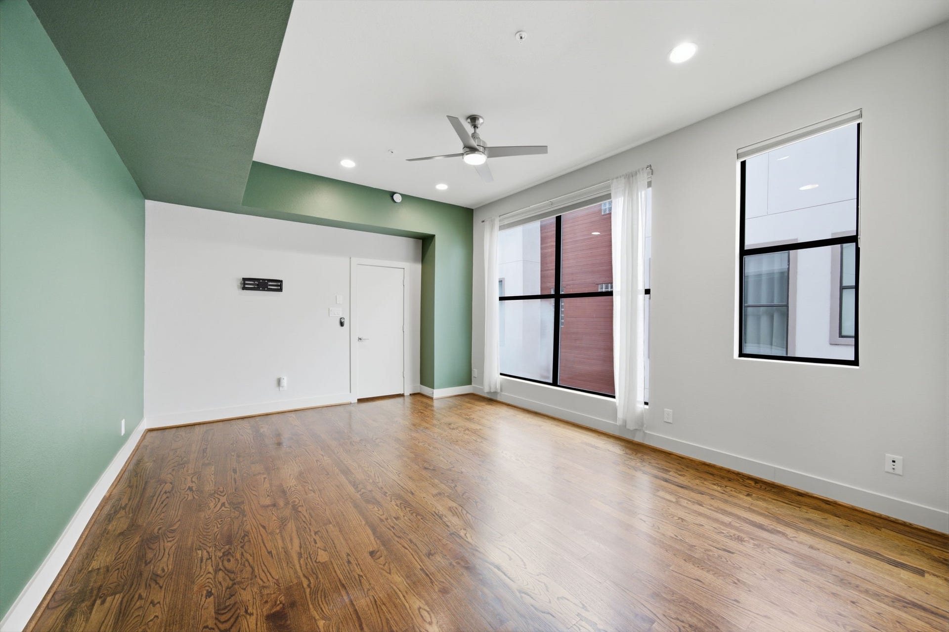 1215 Summer Street, #C, Houston, TX 77007 3rd floor - This is your Primary Bedroom OASIS! HUGE WINDOWS letting in so much natural light! Deep green paint and WOOD floors anchoring the space!