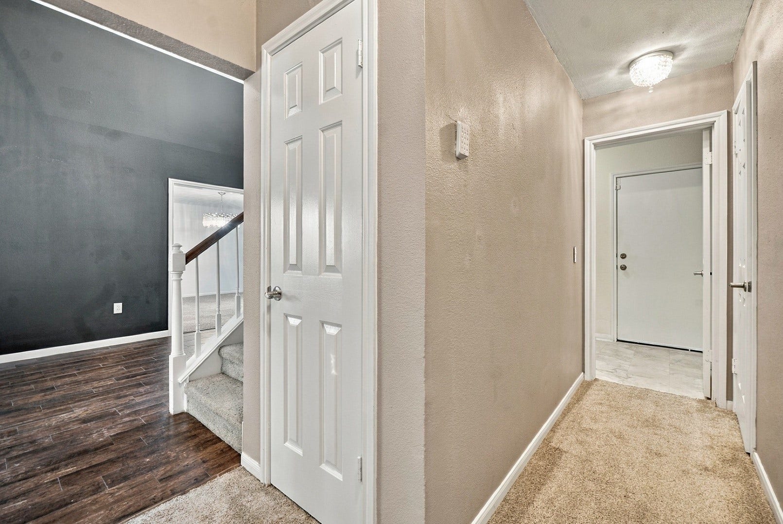 Hallway from Primary - to the right is the laundry room and a half bath