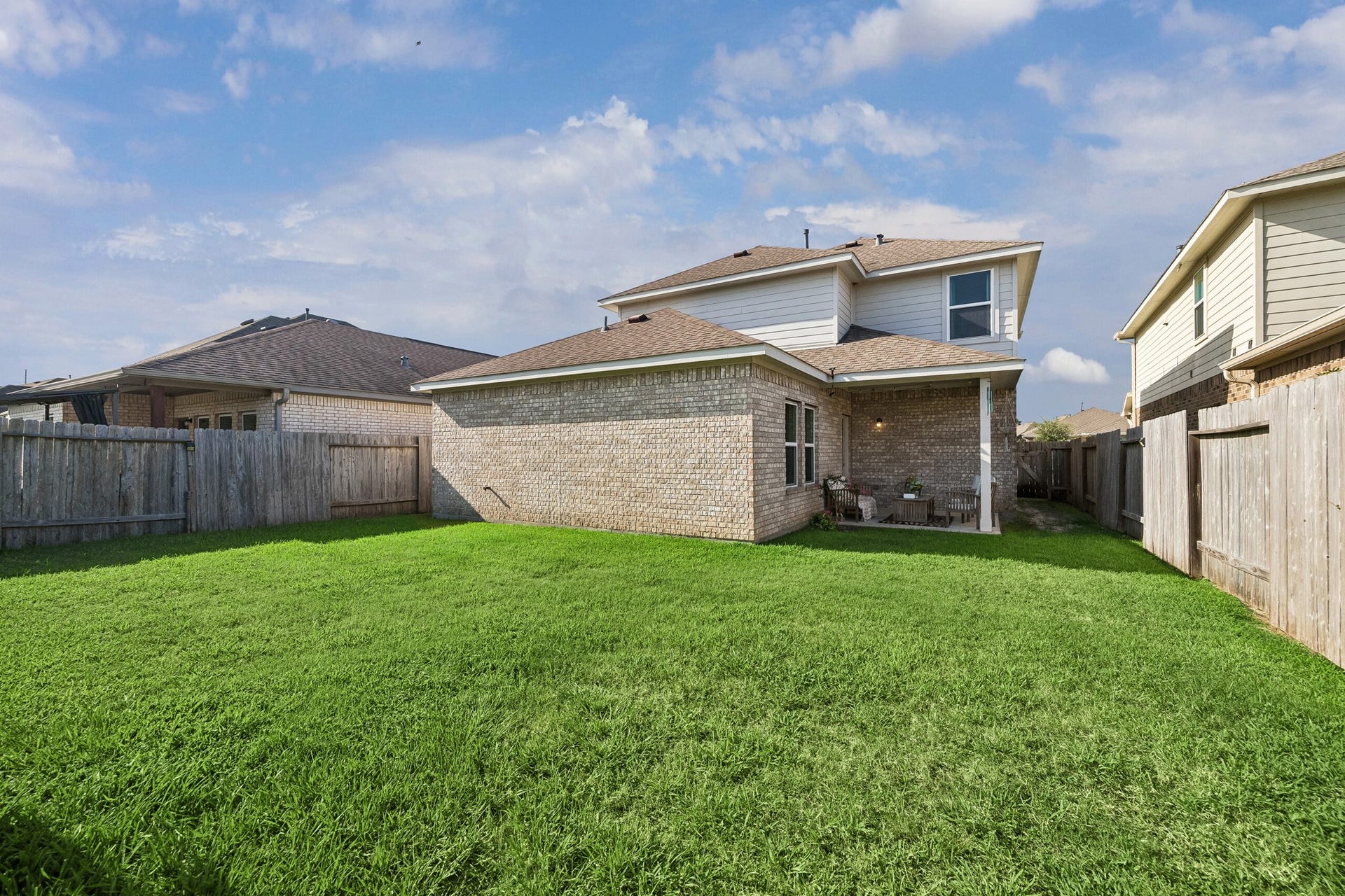 21264 Flowering Crape Myrtle Drive, Porter, TX 77365 Look how the covered patio is tucked away to enjoy shade while everyone can enjoy all the green space.