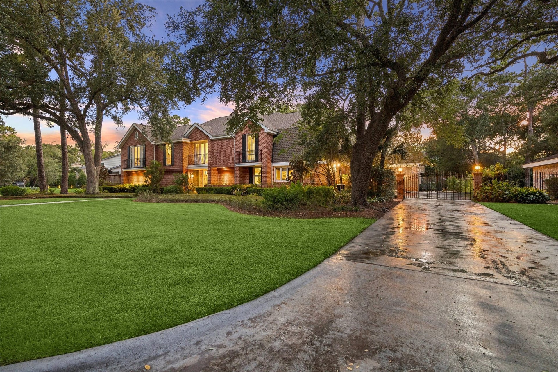 14 Stonegate Drive, Houston, TX 77024 Long driveway leading to a gated motor court and three-car garage.