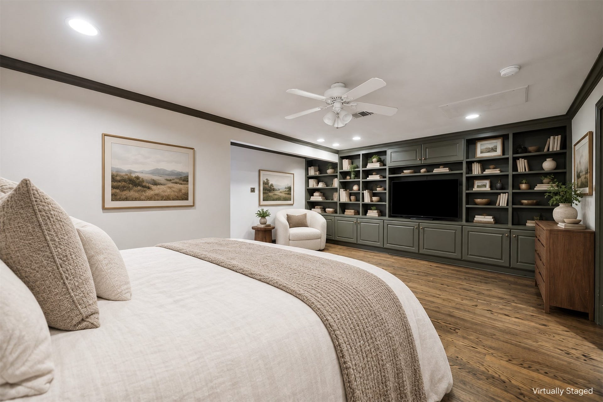14 Stonegate Drive, Houston, TX 77024 Virtually Staged - Spacious primary bedroom features elegant oak flooring and a cozy seating area.