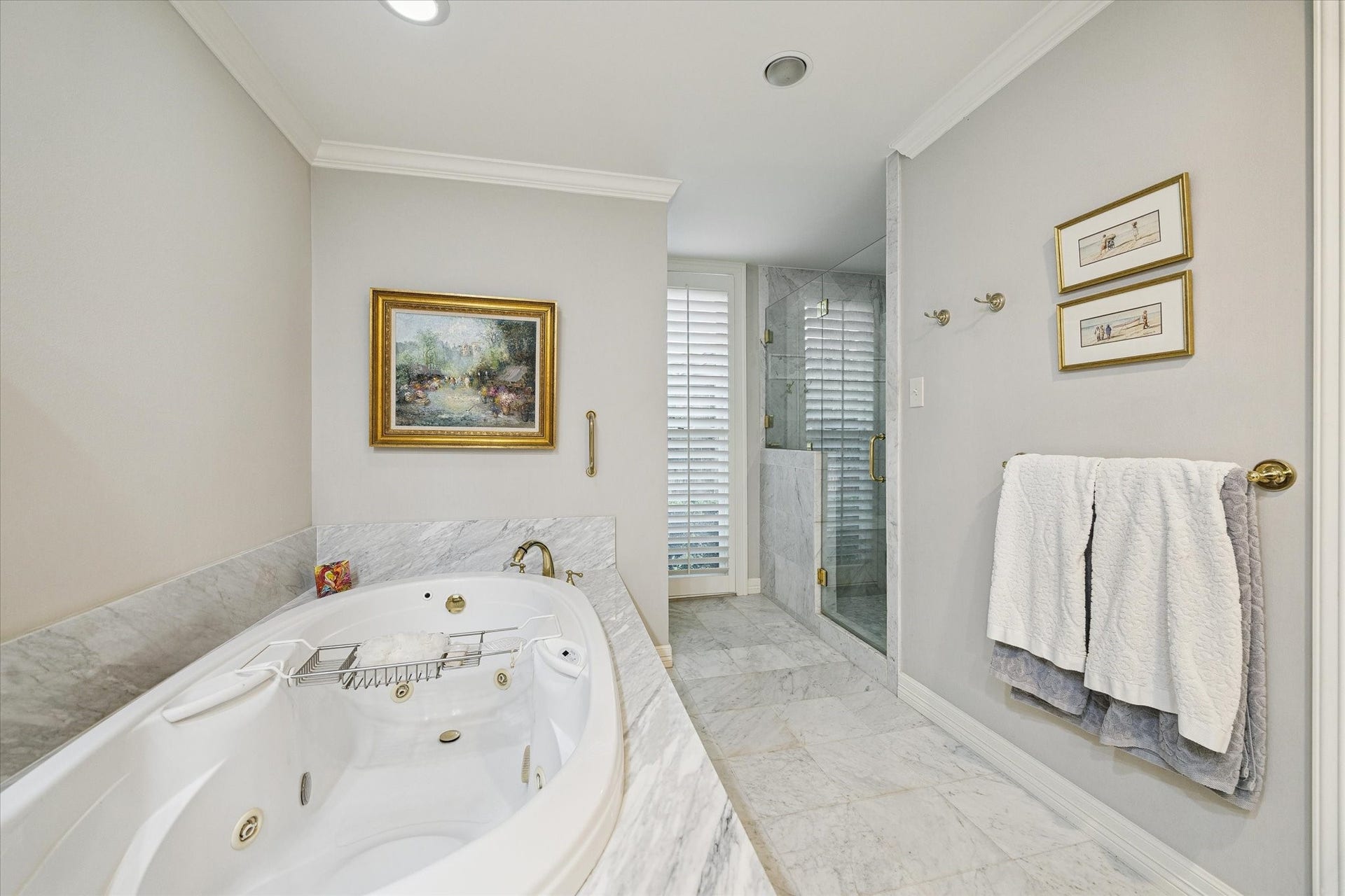 14 Stonegate Drive, Houston, TX 77024 A whirlpool tub, a sleek glass-enclosed shower, and sophisticated marble finishes for a serene retreat.