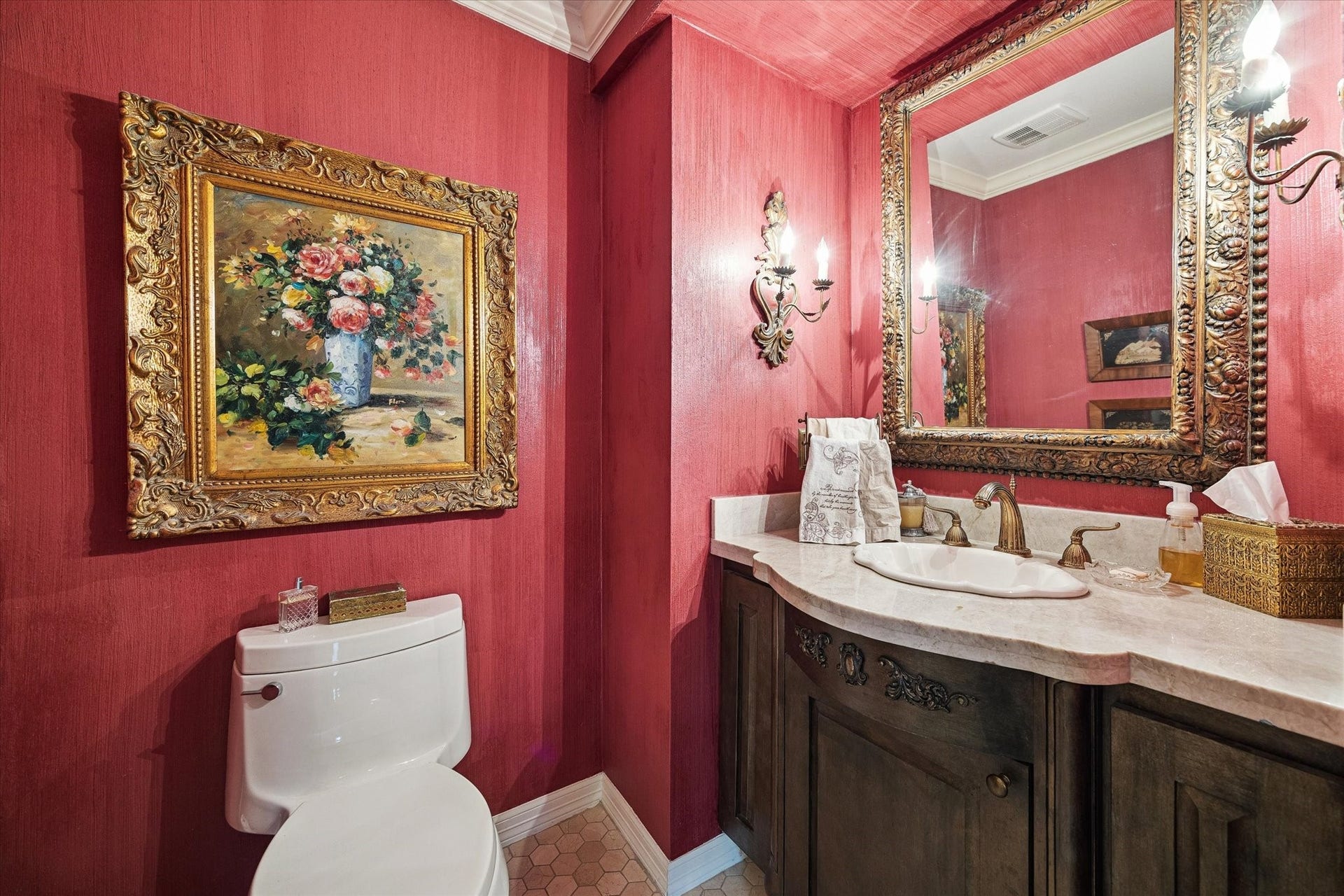 14 Stonegate Drive, Houston, TX 77024 A fun powder bath, featuring rich red walls and ornate gold accents that exude timeless charm.