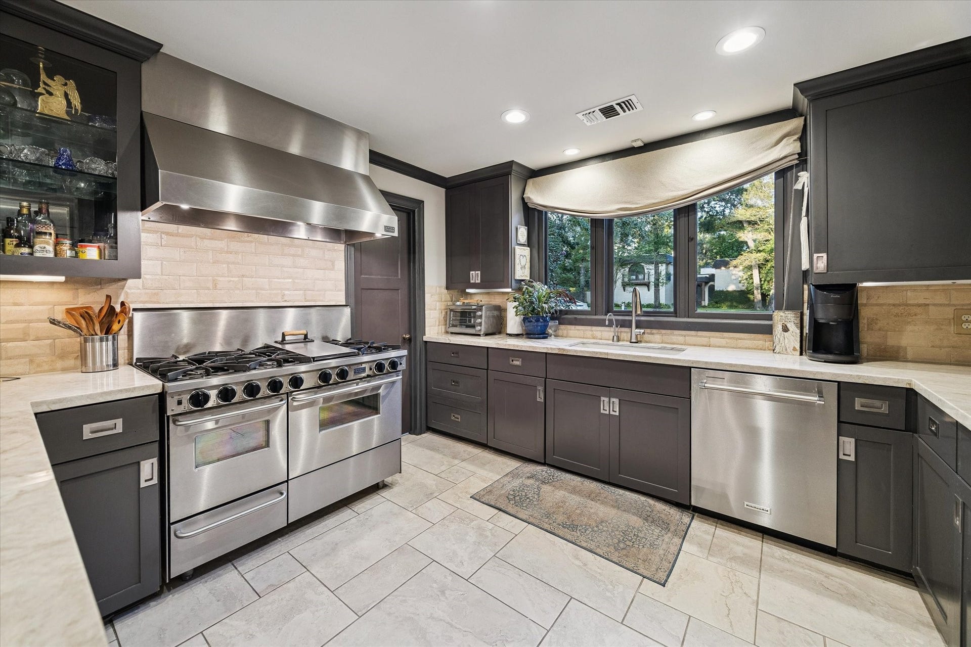 14 Stonegate Drive, Houston, TX 77024 Kitchen features a professional-grade stainless steel range and vent hood.