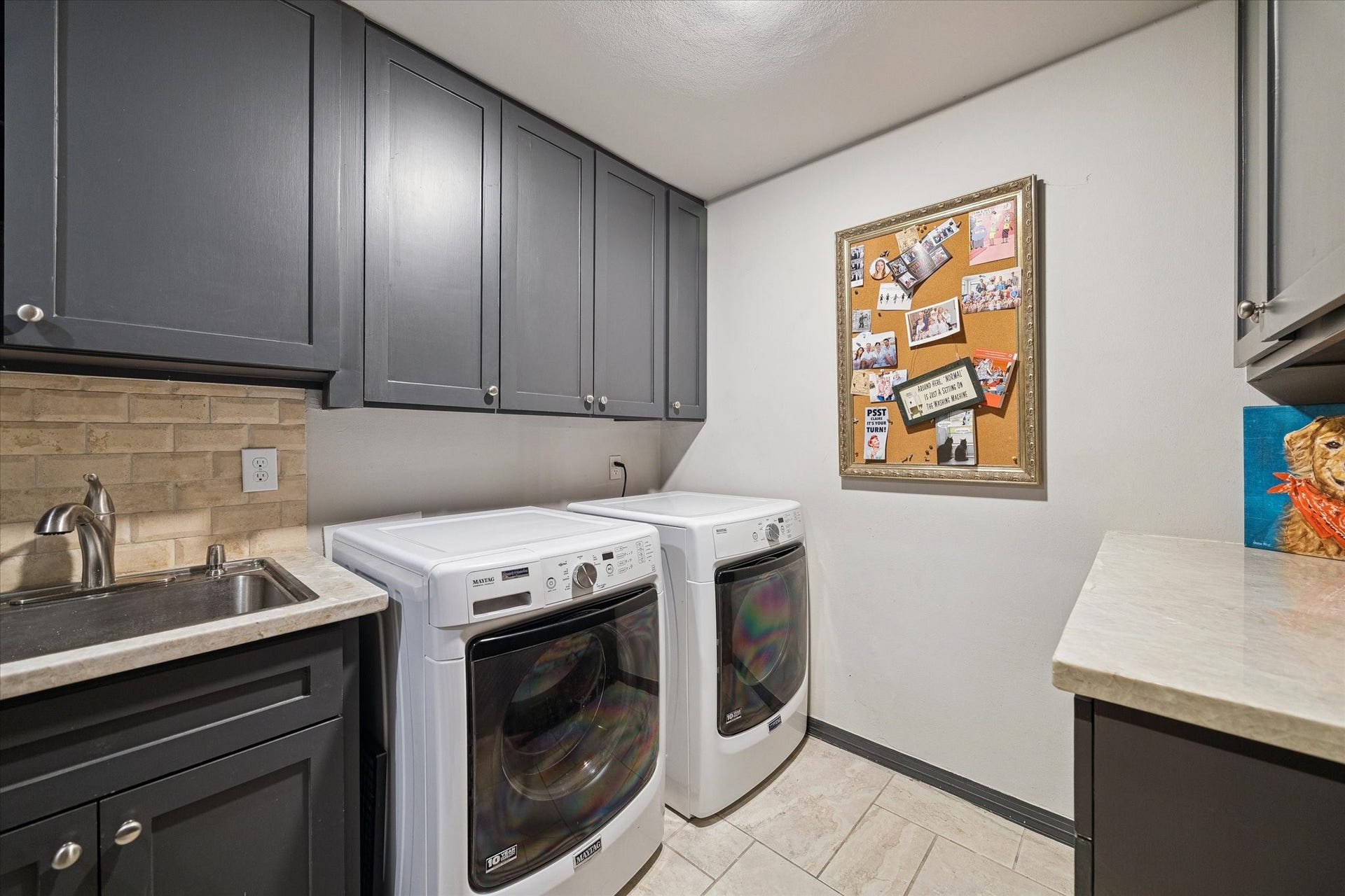 14 Stonegate Drive, Houston, TX 77024 Manage household chores in this well-appointed utility room featuring updated cabinetry and ample counter space for all your organizational needs.