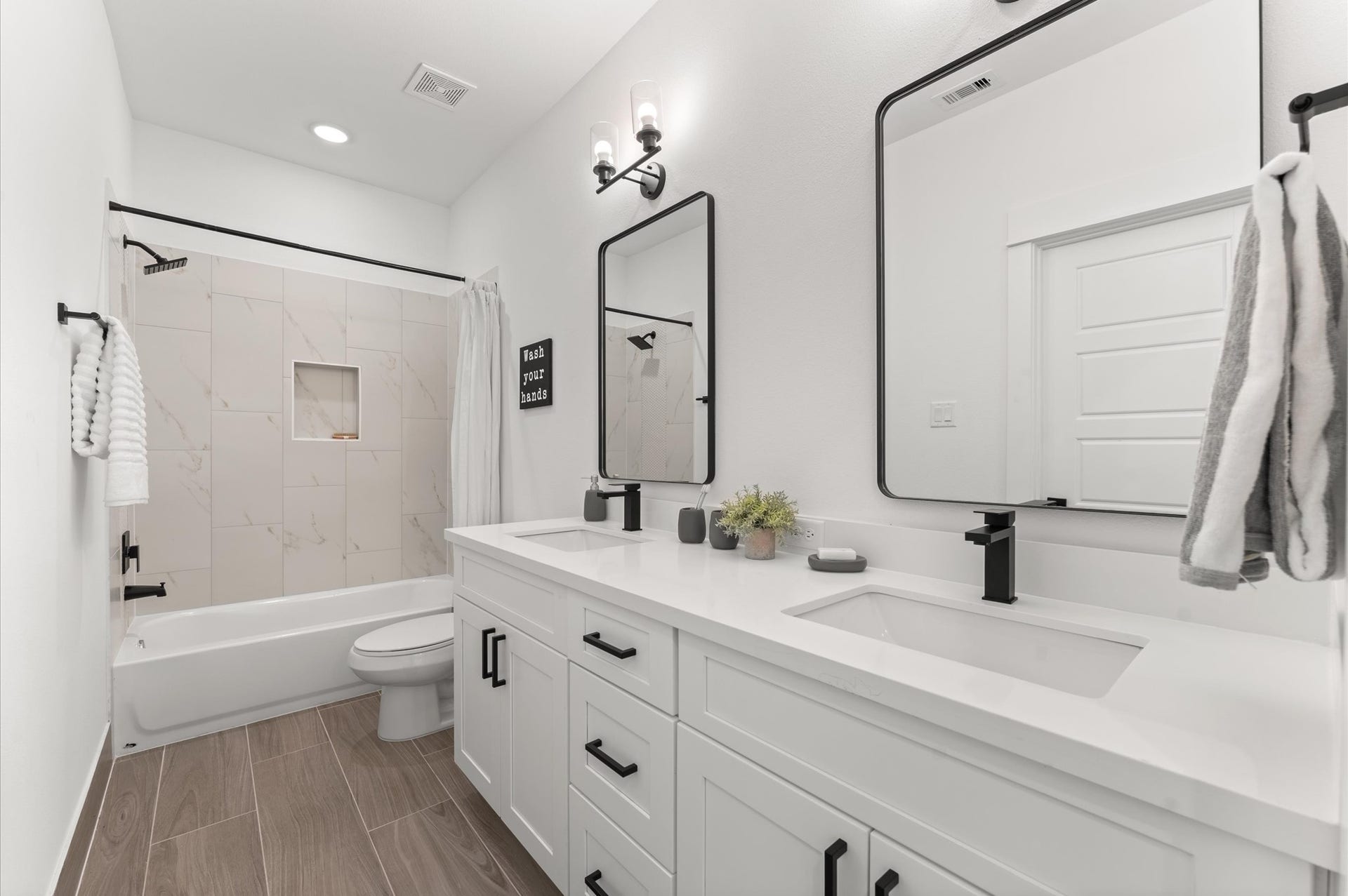 Beautifully appointed Jack and Jill bathroom nestled between the two secondary bedrooms on the first floor, designed to balance style and functionality. Each bedroom enjoys private access to the shared space, which features a sleek tub-shower comboperfect for both quick rinses and relaxing soaks.