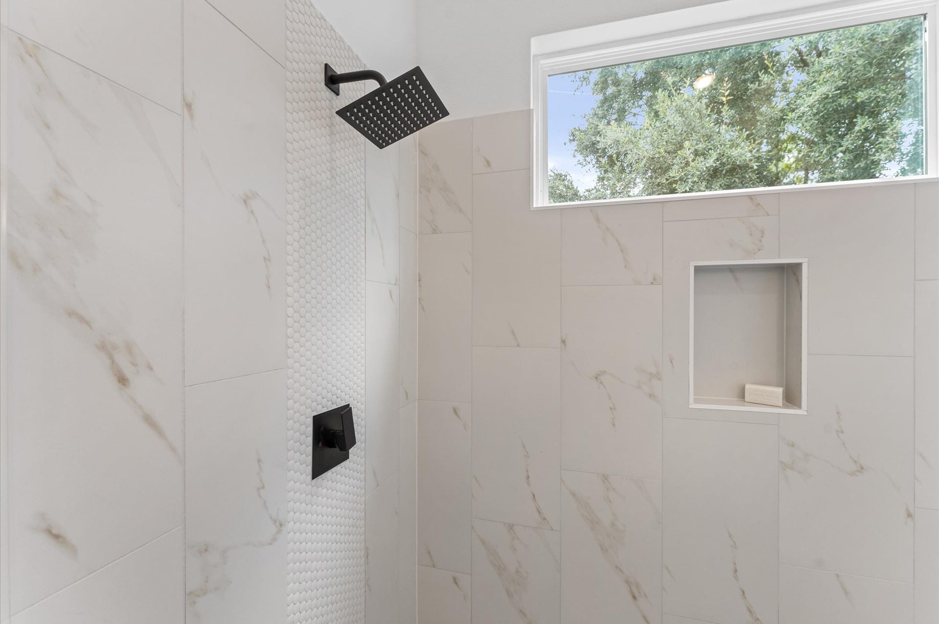 Elegant and serene primary bathroom designed to offer both style and functionality. The space features a luxurious soaking tub ideal for unwinding, a separate glass-enclosed shower for quick refreshes, and a sleek double vanity with ample countertop space and storageperfect for busy mornings or relaxing evenings.