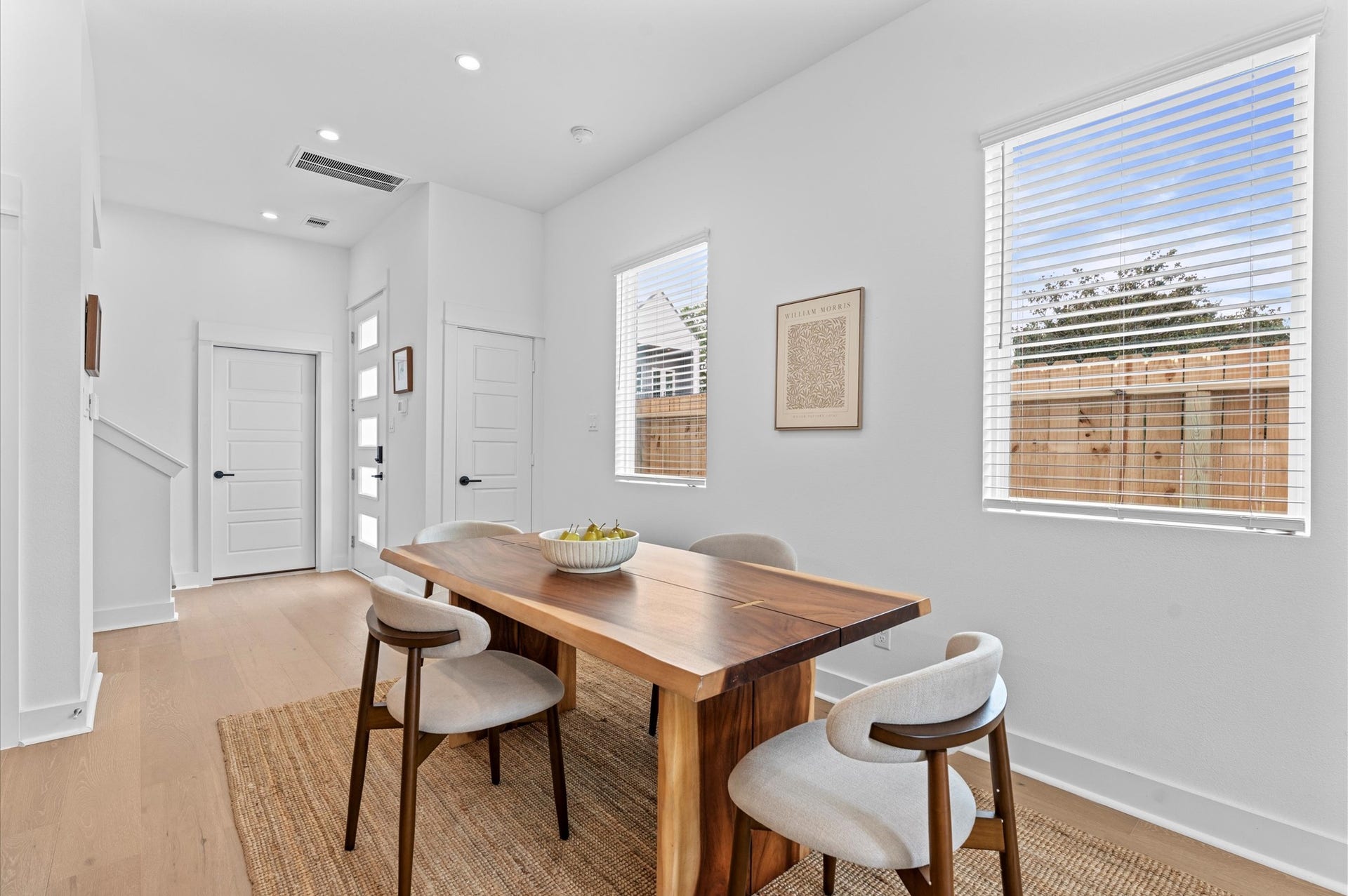 Adjacent dining area easily accommodates a full-size table, while the living space is inviting with cozy seating and access to a private balcony