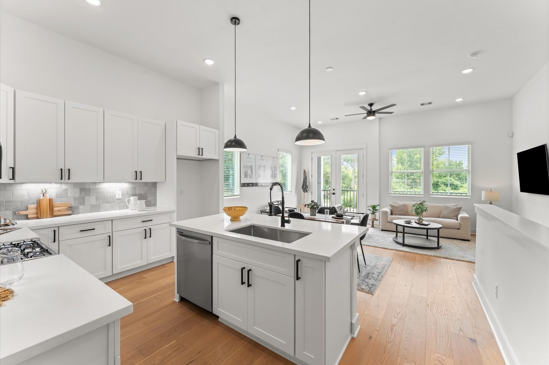This stylish kitchen island anchors the heart of the home, offering clear sightlines to the adjacent living area. Positioned for both function and connection, the island features sleek countertops, bar seating, and pendant lighting that adds a touch of sophistication. Photos from the model home - layout and finishes will change!