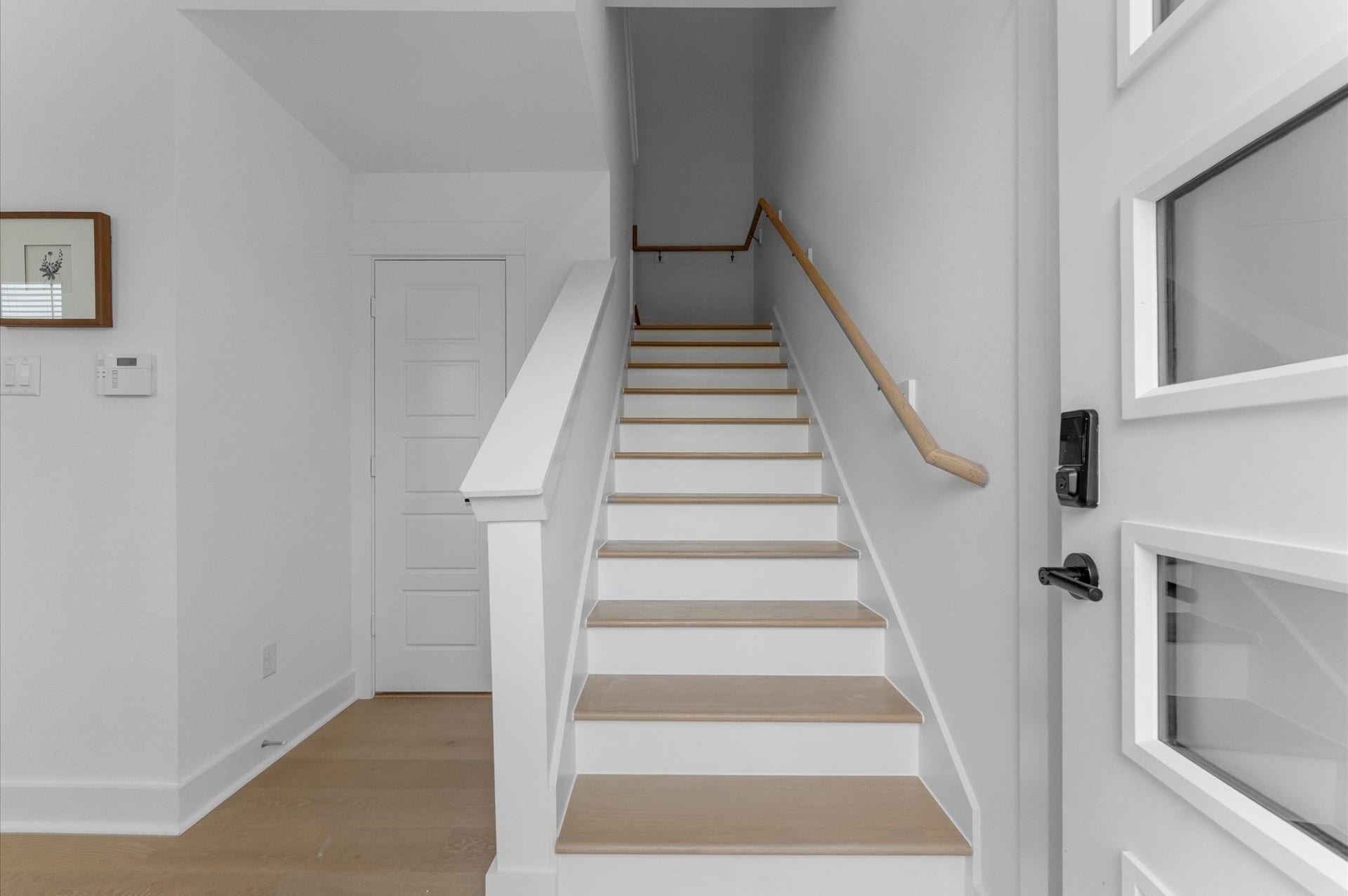 Elegant staircase serves as a stylish transition from the first to the second floor, combining architectural charm with functional design.