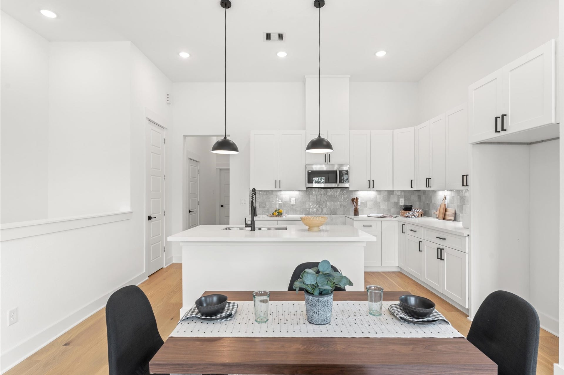 Adjacent dining area easily accommodates a full-size table, while the living space is inviting with cozy seating and access to a private balcony