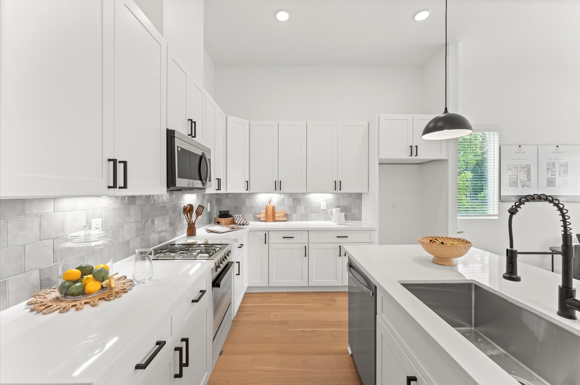 This beautifully designed kitchen showcases abundant cabinetry along the perimeter, offering generous storage for cookware, pantry items, and everyday essentials. The sleek kitchen island serves as both a functional prep space and a stylish centerpiece, featuring built-in cabinets and drawers that maximize organization.