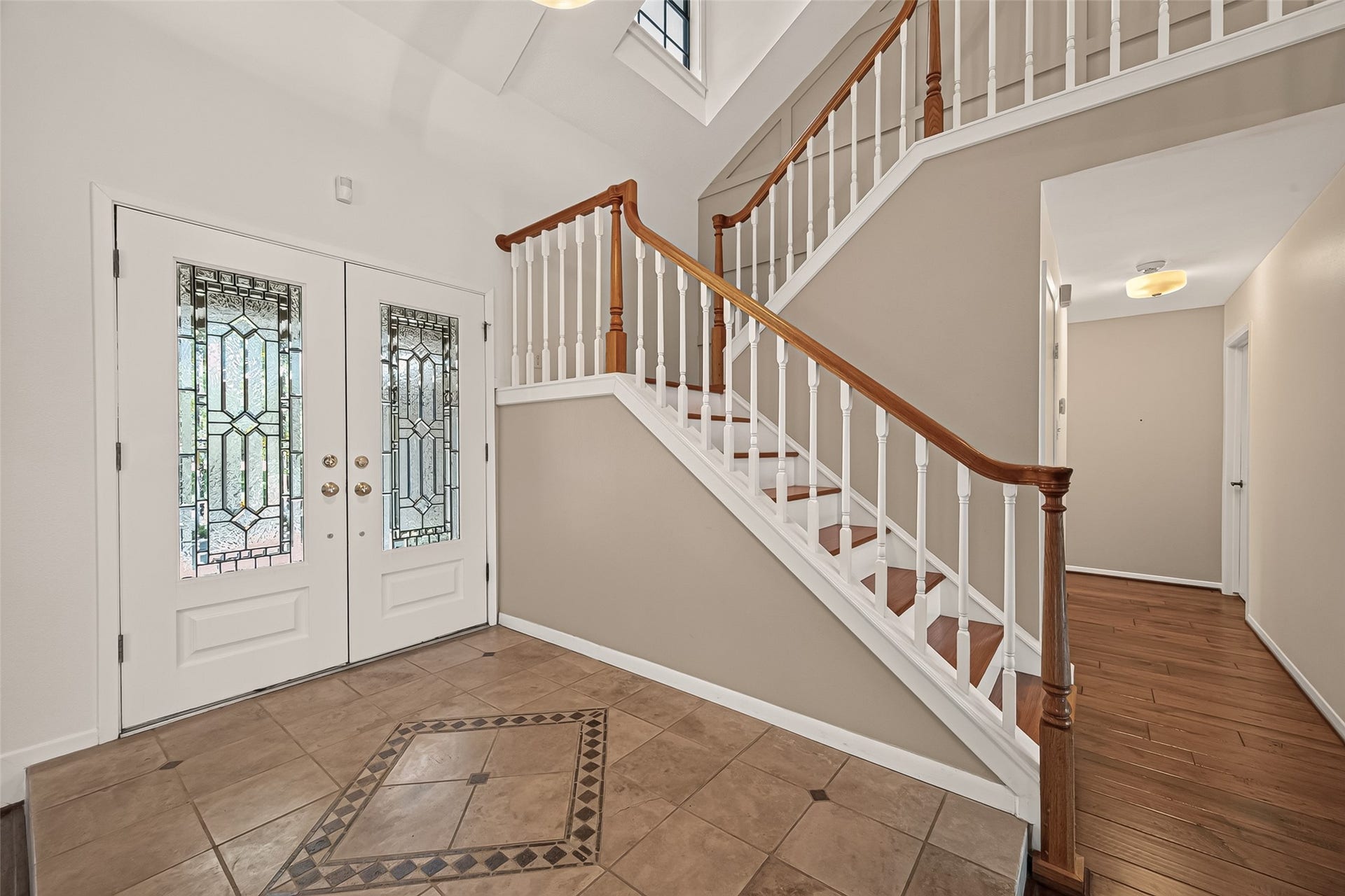 Custom tile entry marks the foyer and greets guests in style.