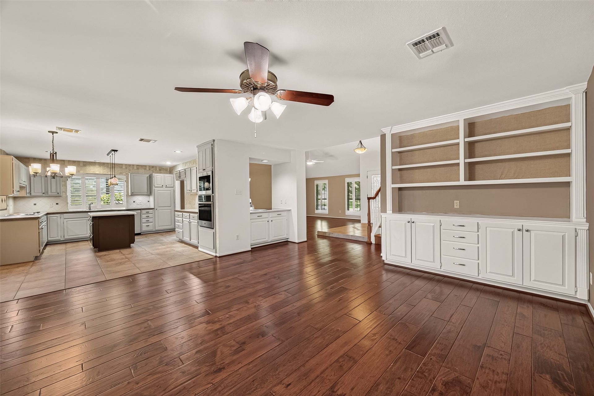 Custom built in shelves allow for decor, storage and display. Warm flooring flows through main living areas. Neutral finishes throughout will compliment any design style. Pass through buffet/dry bar area makes entertaining a snap!