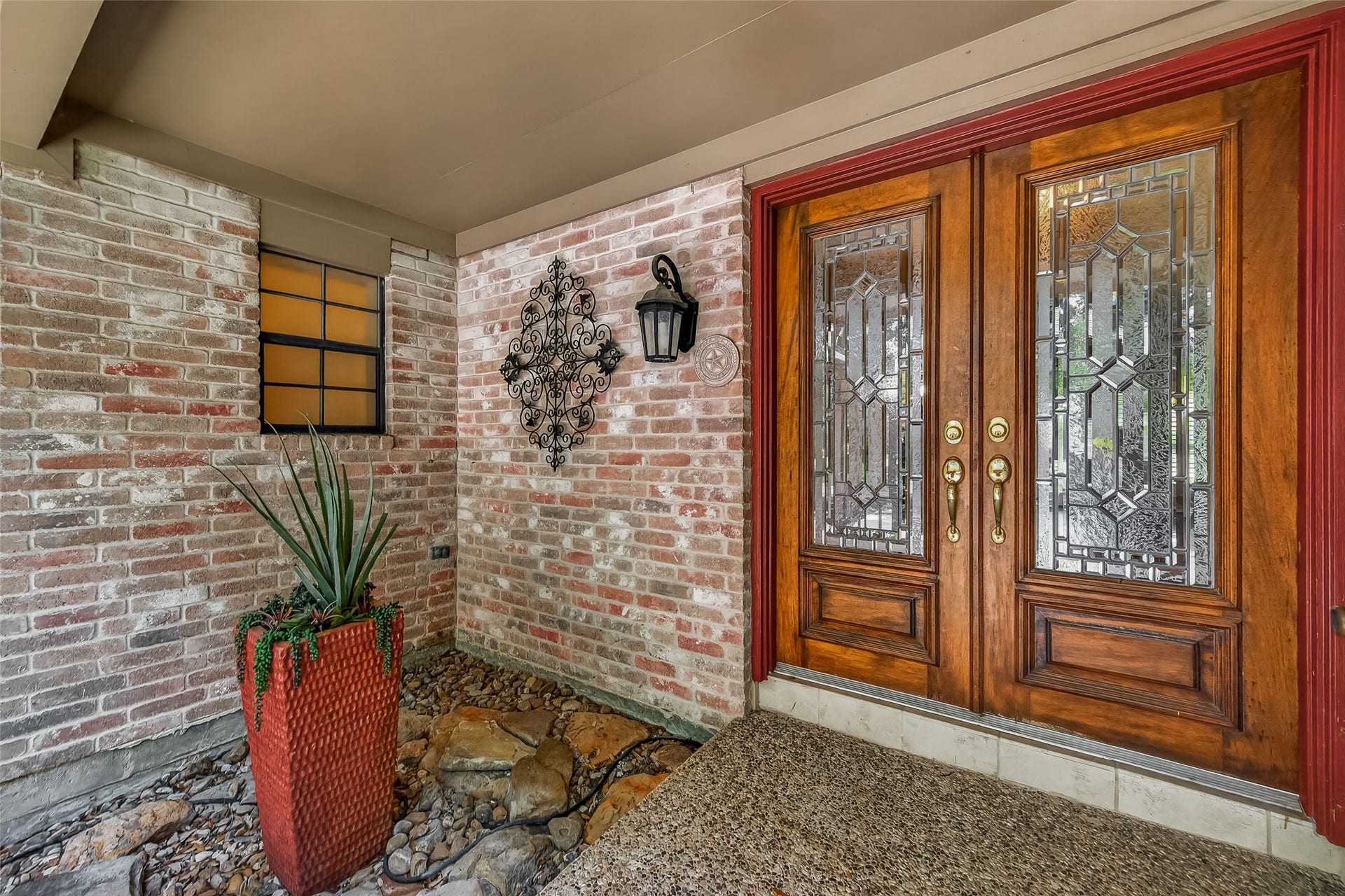 Serene gated entry with double leaded glass front doors.