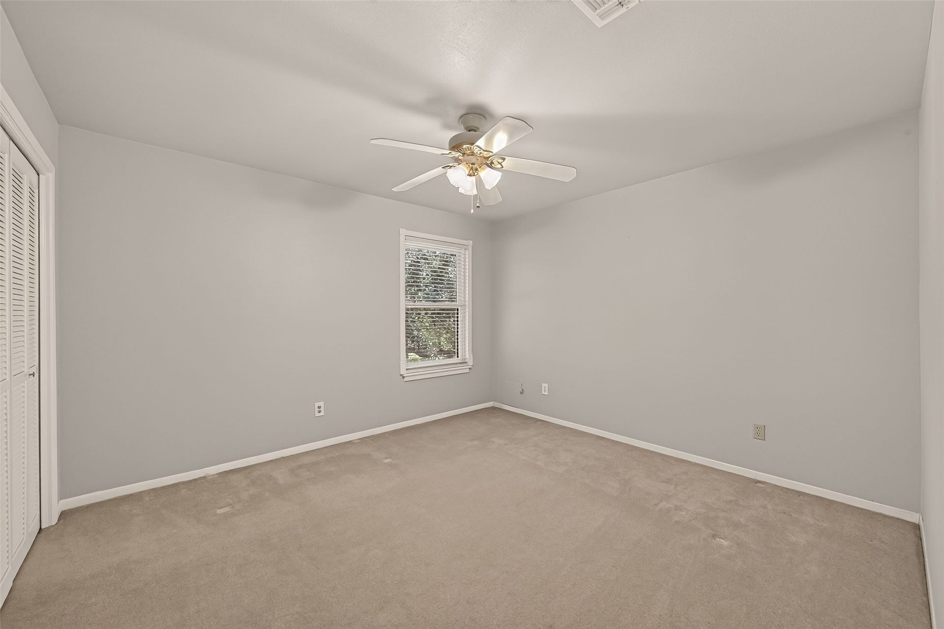 2nd bedroom upstairs is finished in a tasteful neutral palette.