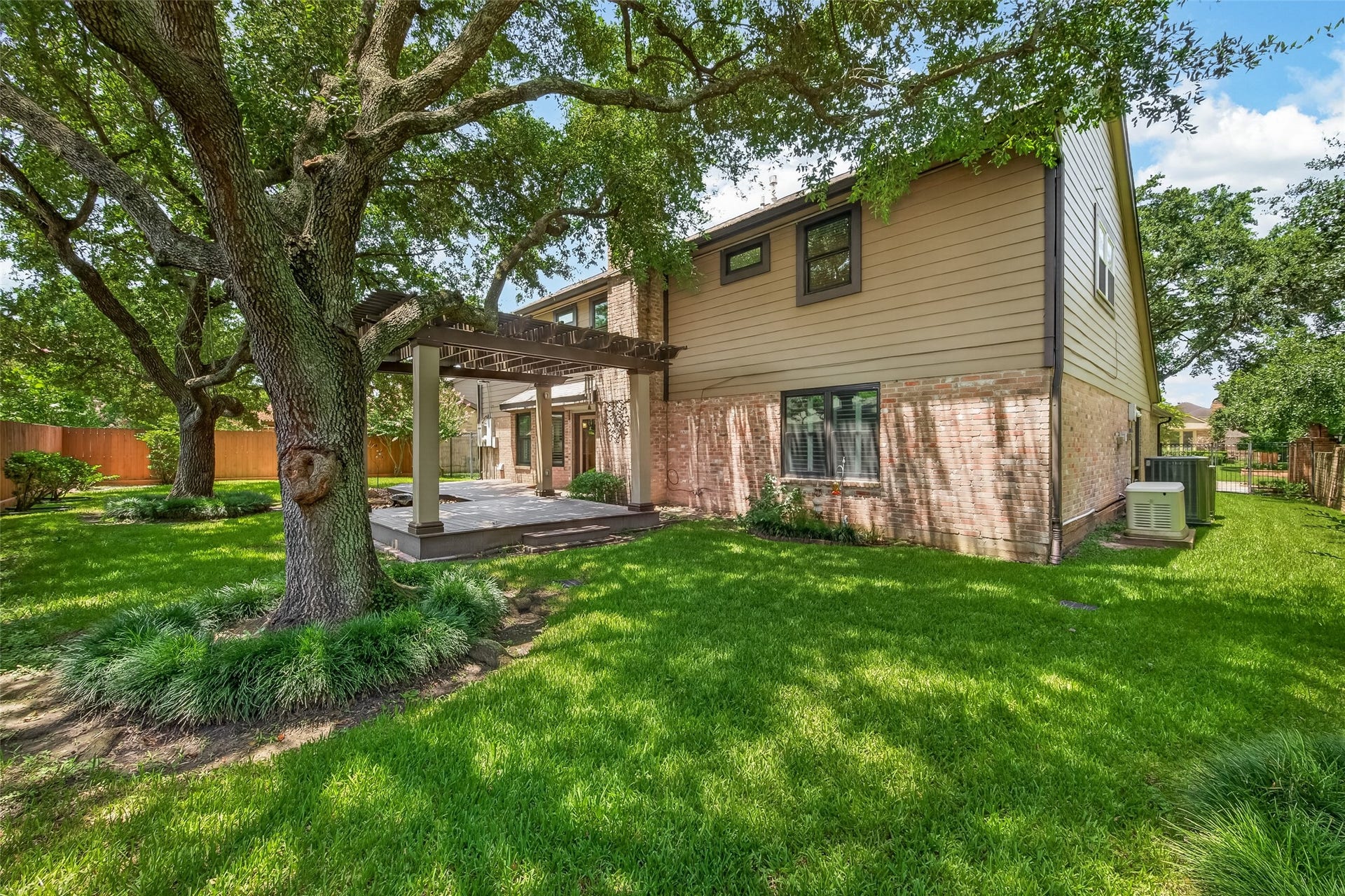 Plenty of yard space and low maintenance exterior shown here. Don't miss the generator and upgraded HVAC units on the side of the house. This impeccable home is move in ready.
