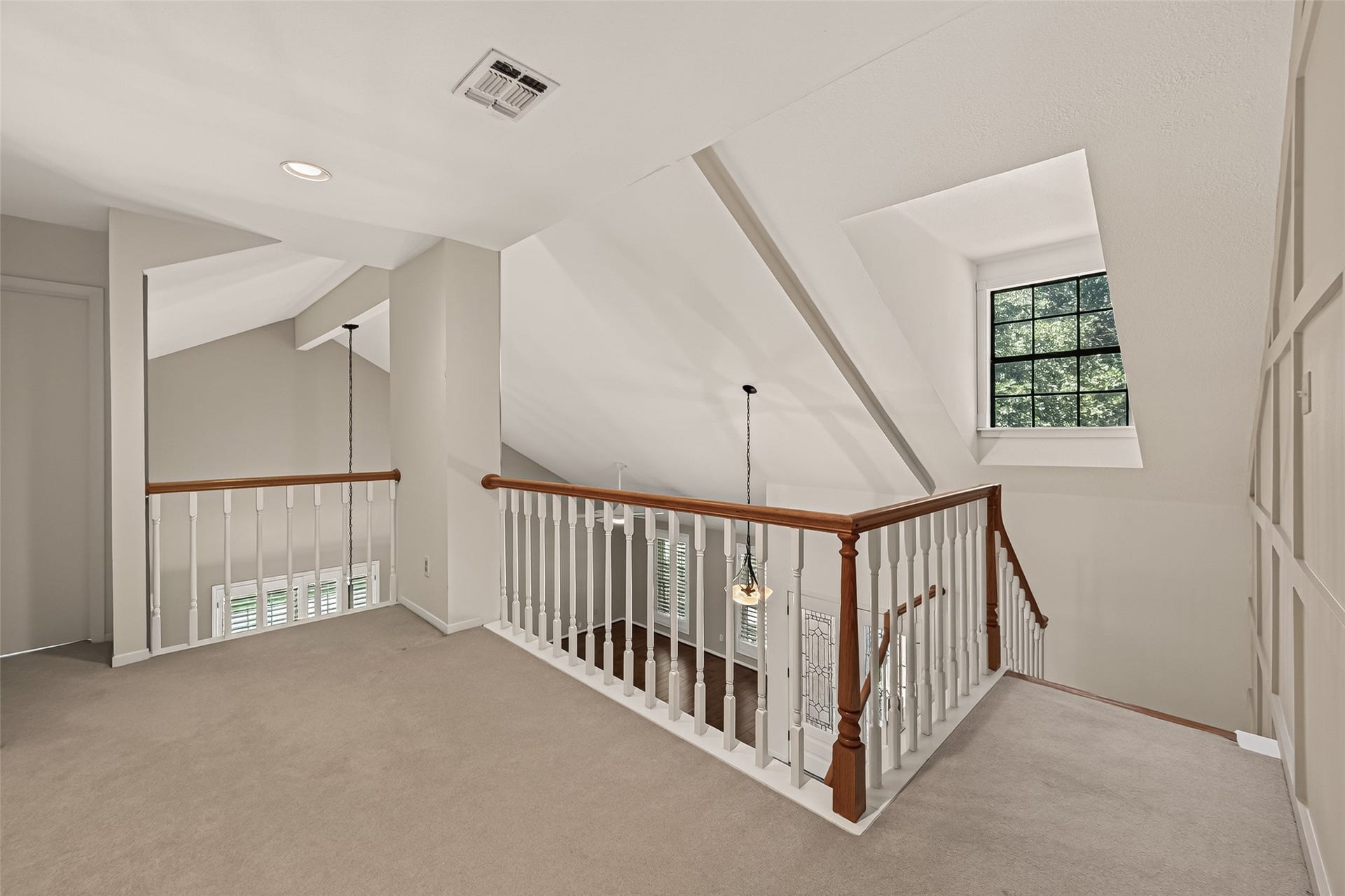 Upstairs landing overlooks formal living area. This could be a study nook, reading niche or a home office space. It could flex for whatever you need!