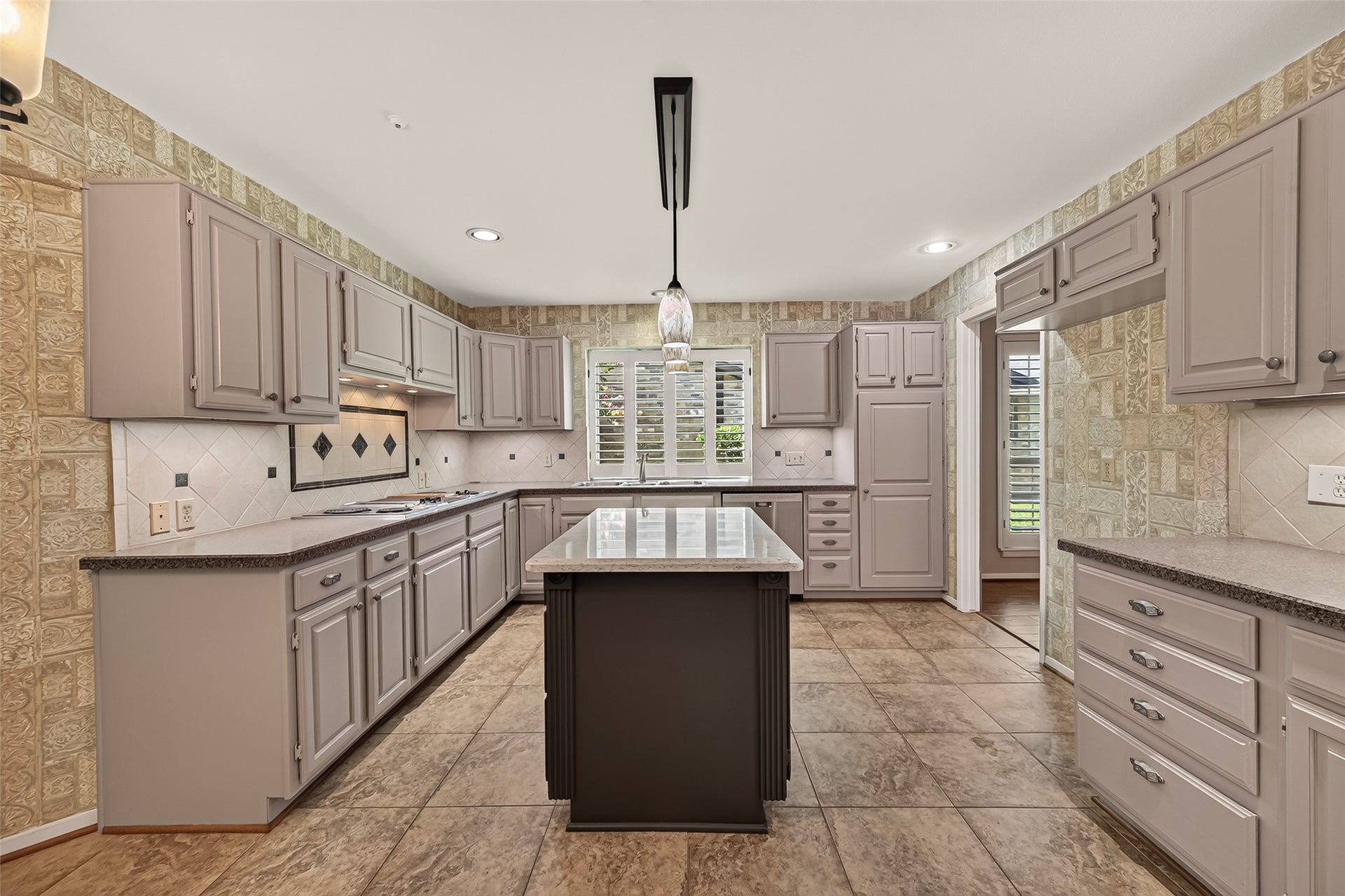 The kitchen is exquisite with beautiful cabinets and a center island w/quartz