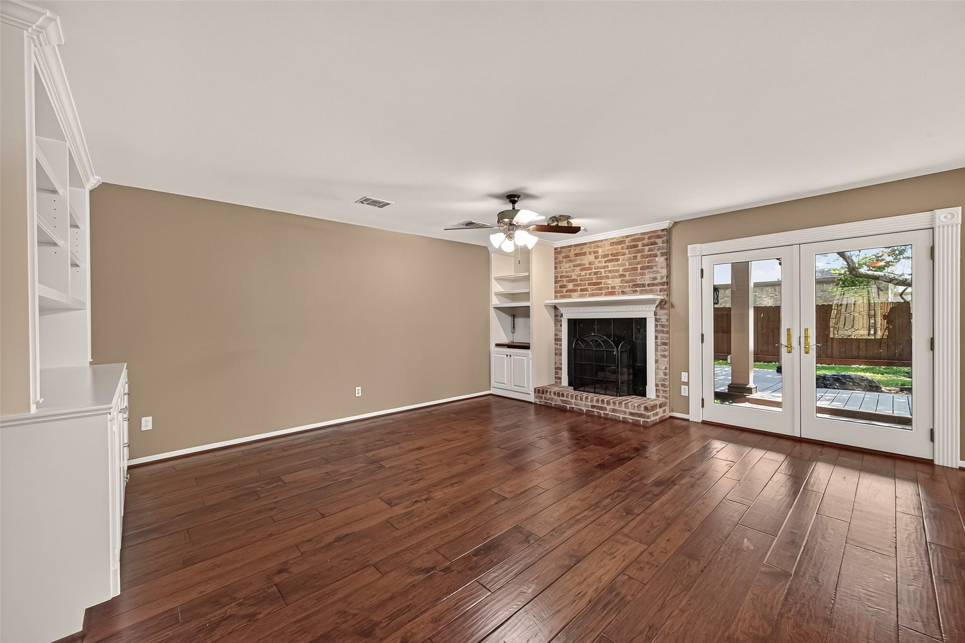 Another family room with fireplace is located adjacent to the kitchen. French doors lead onto the most perfect back patio and manicured yard you've ever seen.
