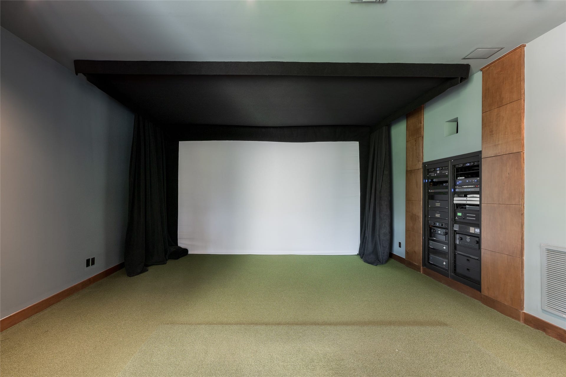 309 Glenwood Drive, Houston, TX 77007 The golf simulator room also serves as the technology hub for the residence, housing the AV rack for the homes Crestron automation system. Centralized controls integrate the homes audio, video and automated features while keeping the equipment discreetly contained.