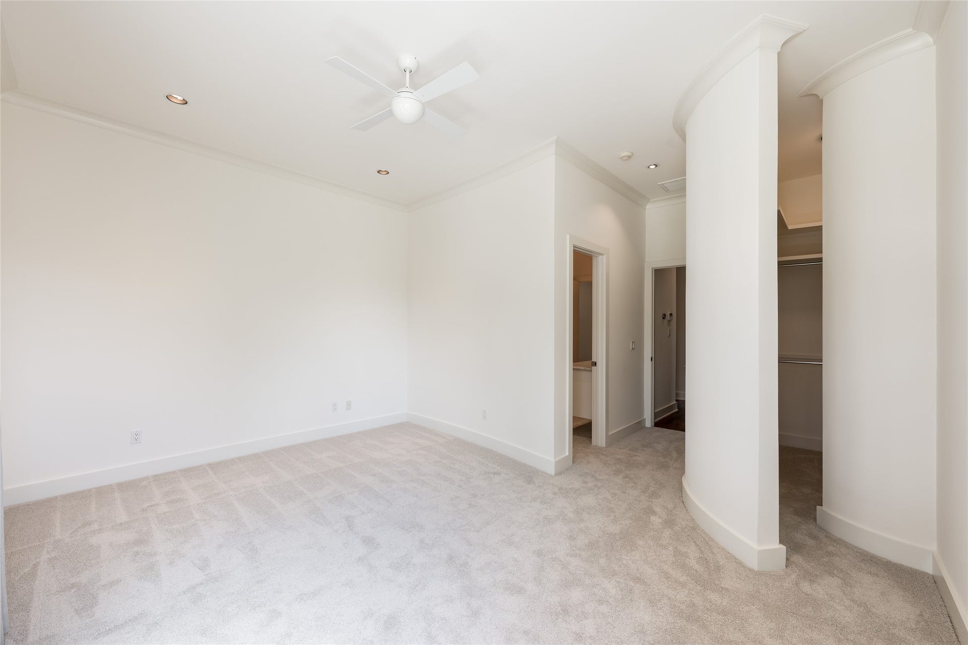 309 Glenwood Drive, Houston, TX 77007 The first secondary bedroom is positioned near the main staircase on the second floor, offering generous proportions and a distinctive walk-in closet that extends beyond the traditional bedroom layout.