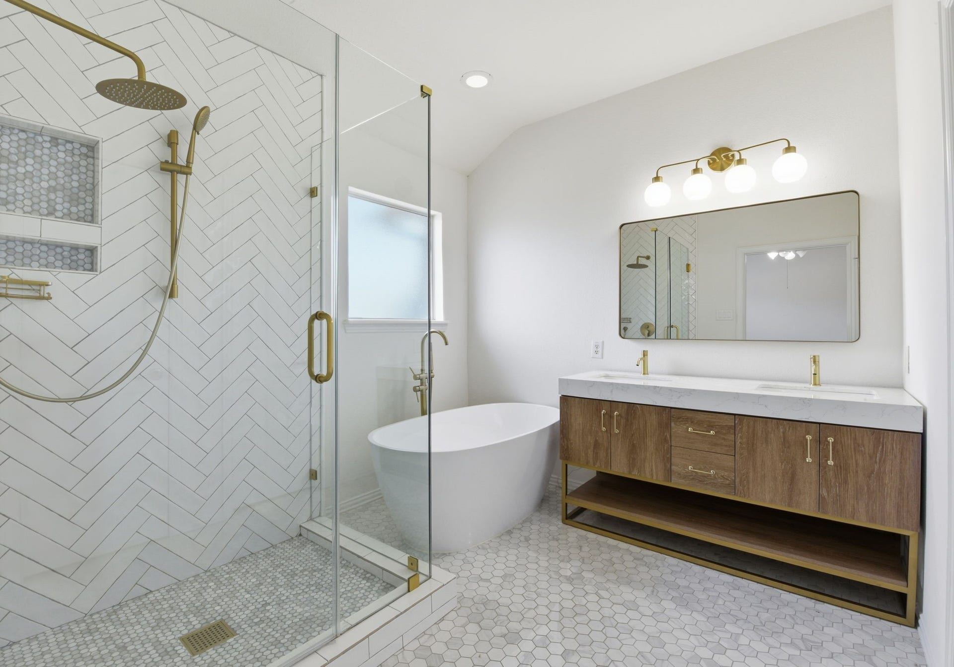 16023 Powder Springs Lane, Houston, TX 77070 This updated primary bath is breathtaking! Notice the updated floors, updated glass enclosed shower, updated vanity, mirror and lighting, along with the updated stand alone soaking tub!