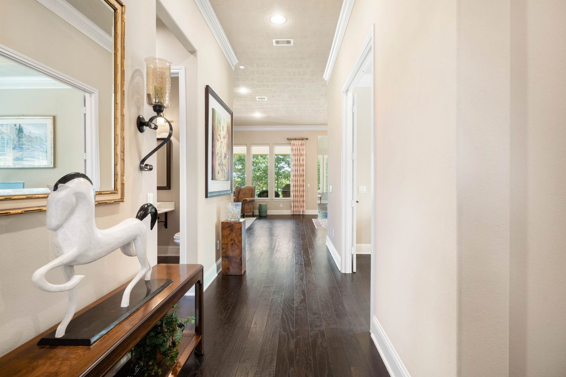 34 Edgemont Court, Fulshear, TX 77441 The foyer welcomes you home with rich hardwood flooring, crown molding, and an open sightline into the main living space.