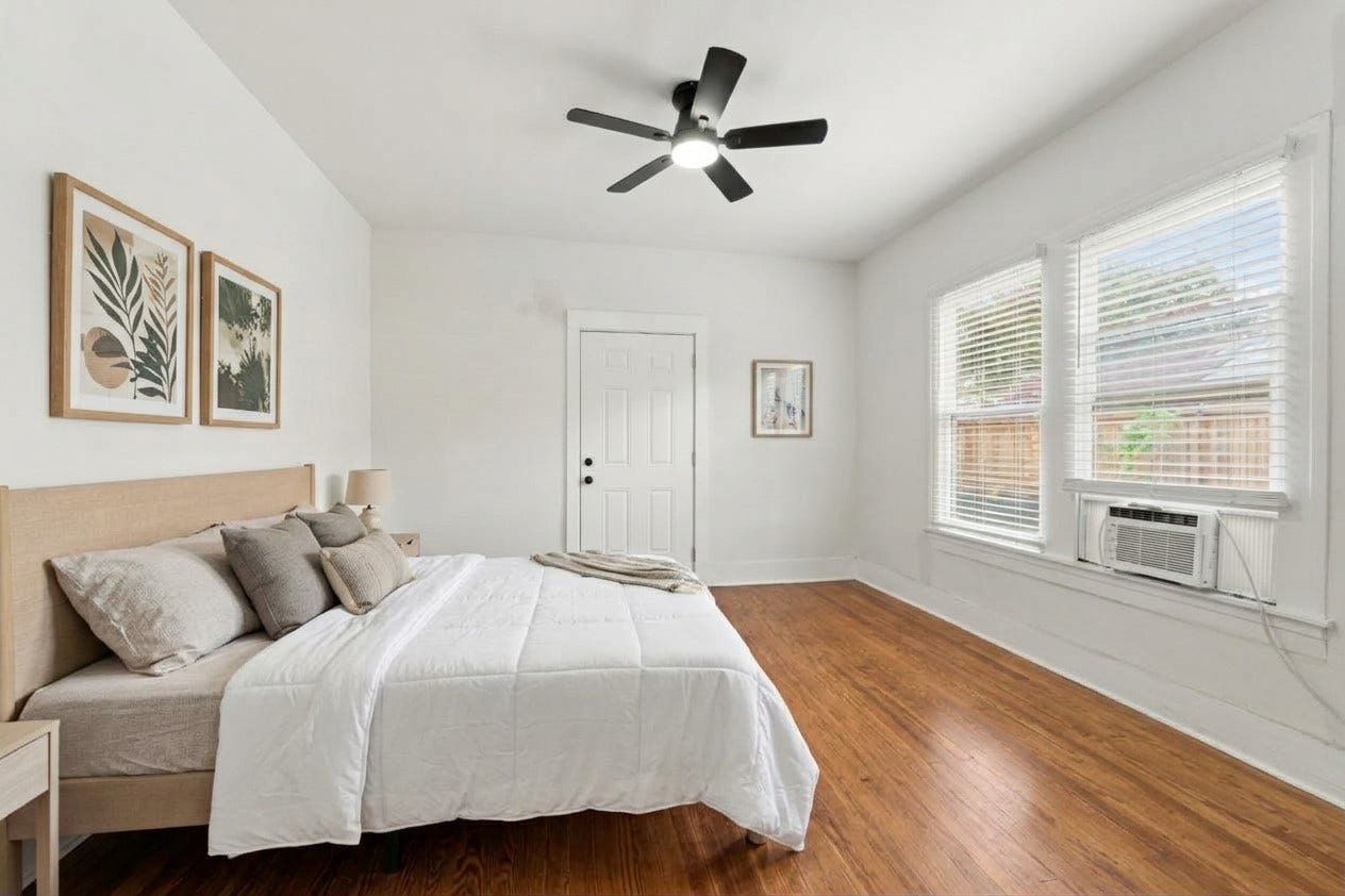 5129 Claremont Street, Houston, TX 77023 Unit 2 bedroom with original pine wood floors. Virtually staged bedroom