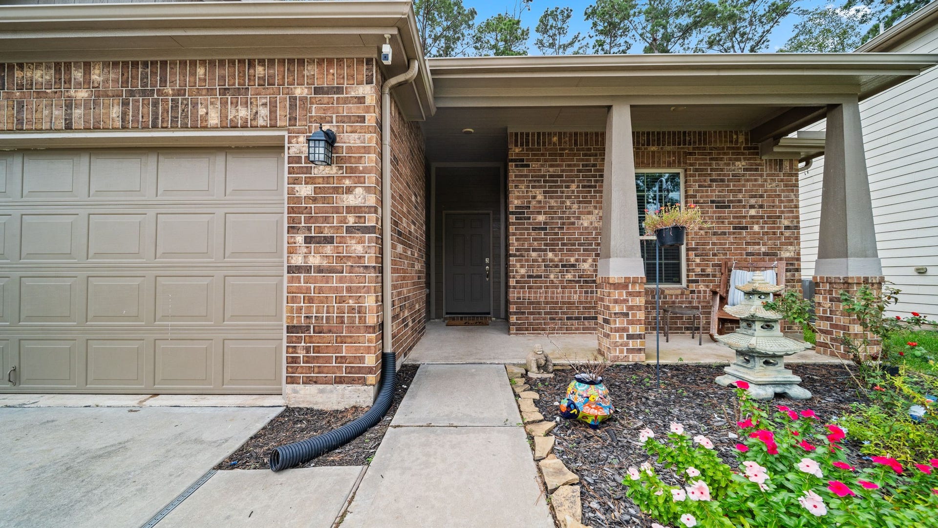 4170 Hidden Timbers Lane, Conroe, TX 77304 Come on in! Enjoy a welcoming covered front porch with attractive landscaping and a sheltered entryway.