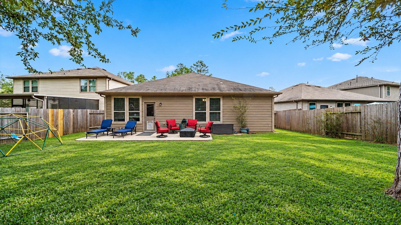 4170 Hidden Timbers Lane, Conroe, TX 77304 Step outside and unwind! The spacious backyard offers a concrete patio, plenty of green space, and a convenient dog door that staysperfect for your four-legged companion! Outdoor furniture and climbing structure not included.