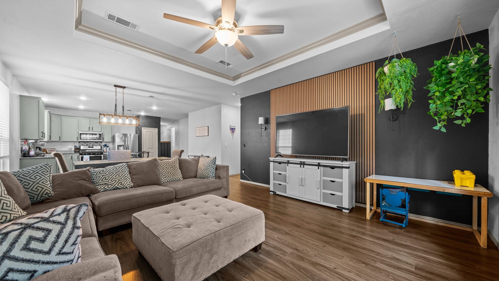 4170 Hidden Timbers Lane, Conroe, TX 77304 Open, bright, and full of character! The living room's beautiful tray ceiling and statement accent wall flow seamlessly into the kitchen and dining areas.
